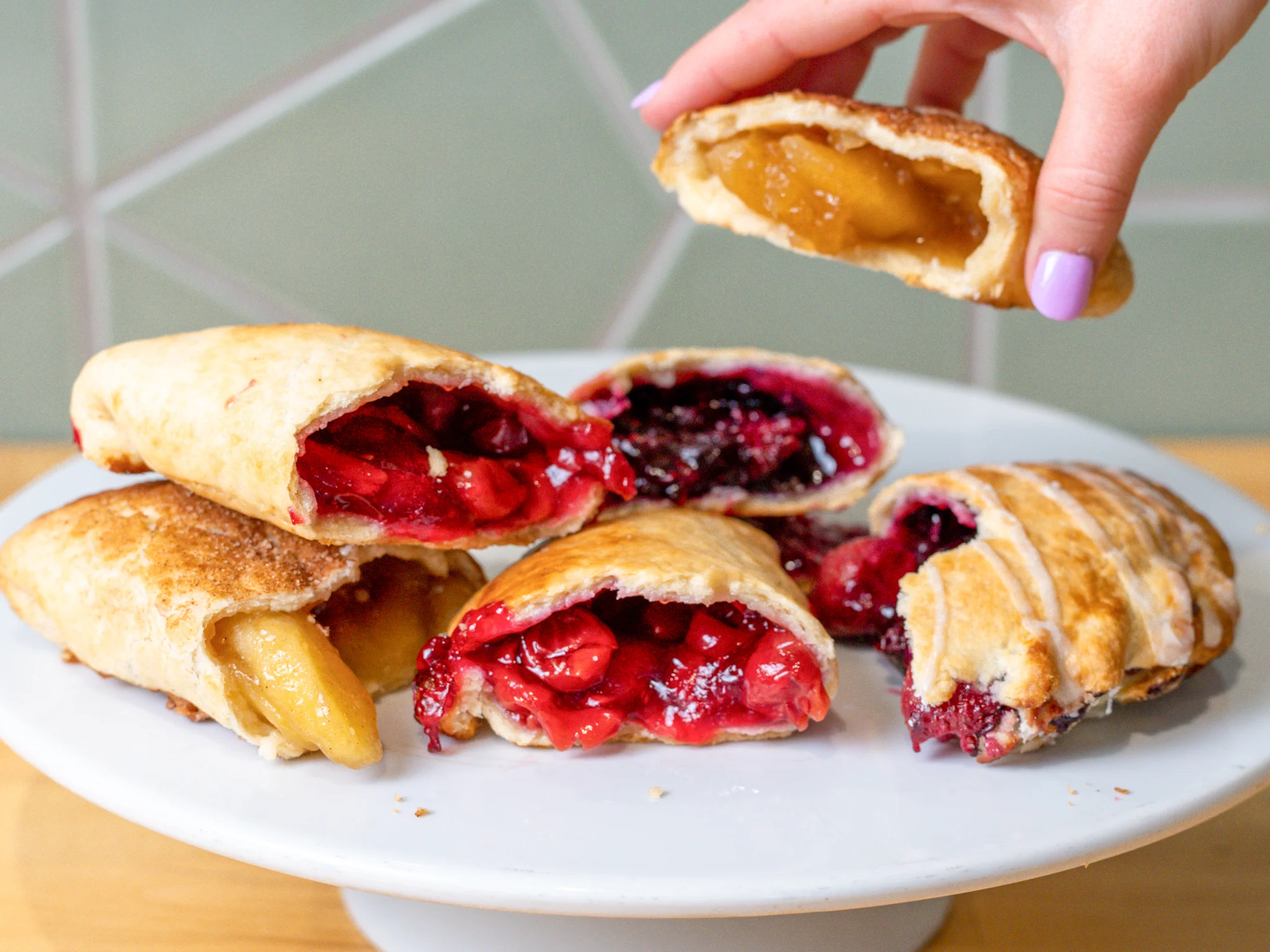 Assorted fruit-filled pastries on a white plate, showcasing various flavors.