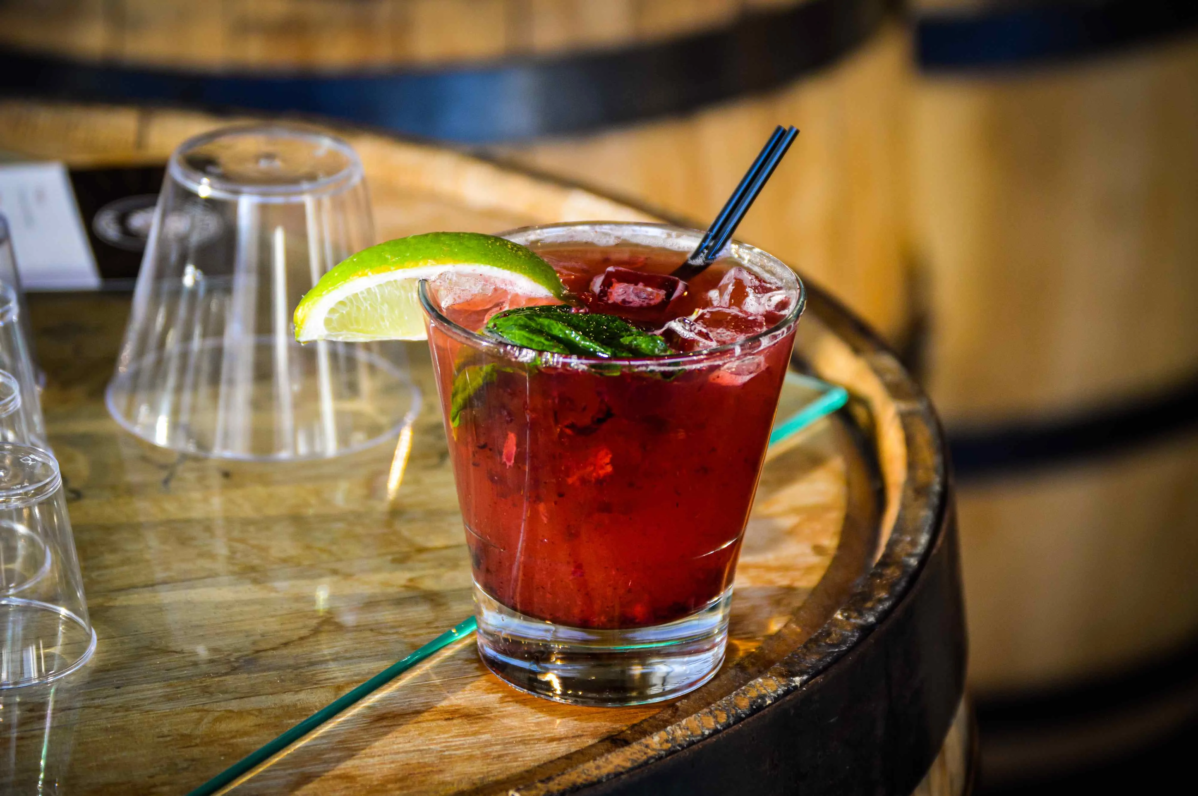 Blackberry Salute cocktail on top of a Driftless Glen barrel