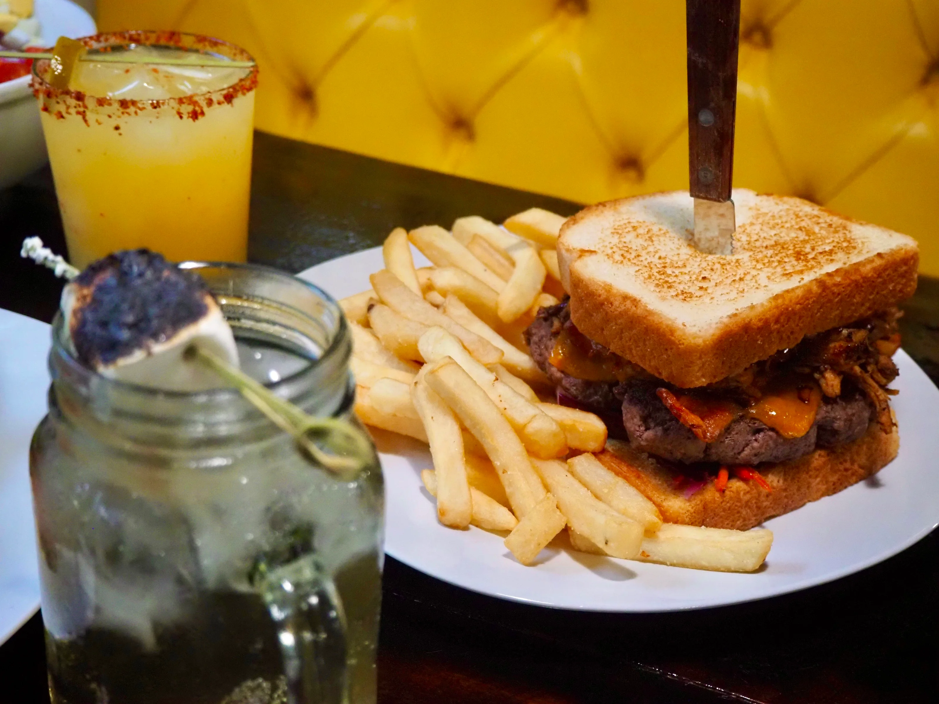 Hearty American burger with fries and a refreshing cocktail