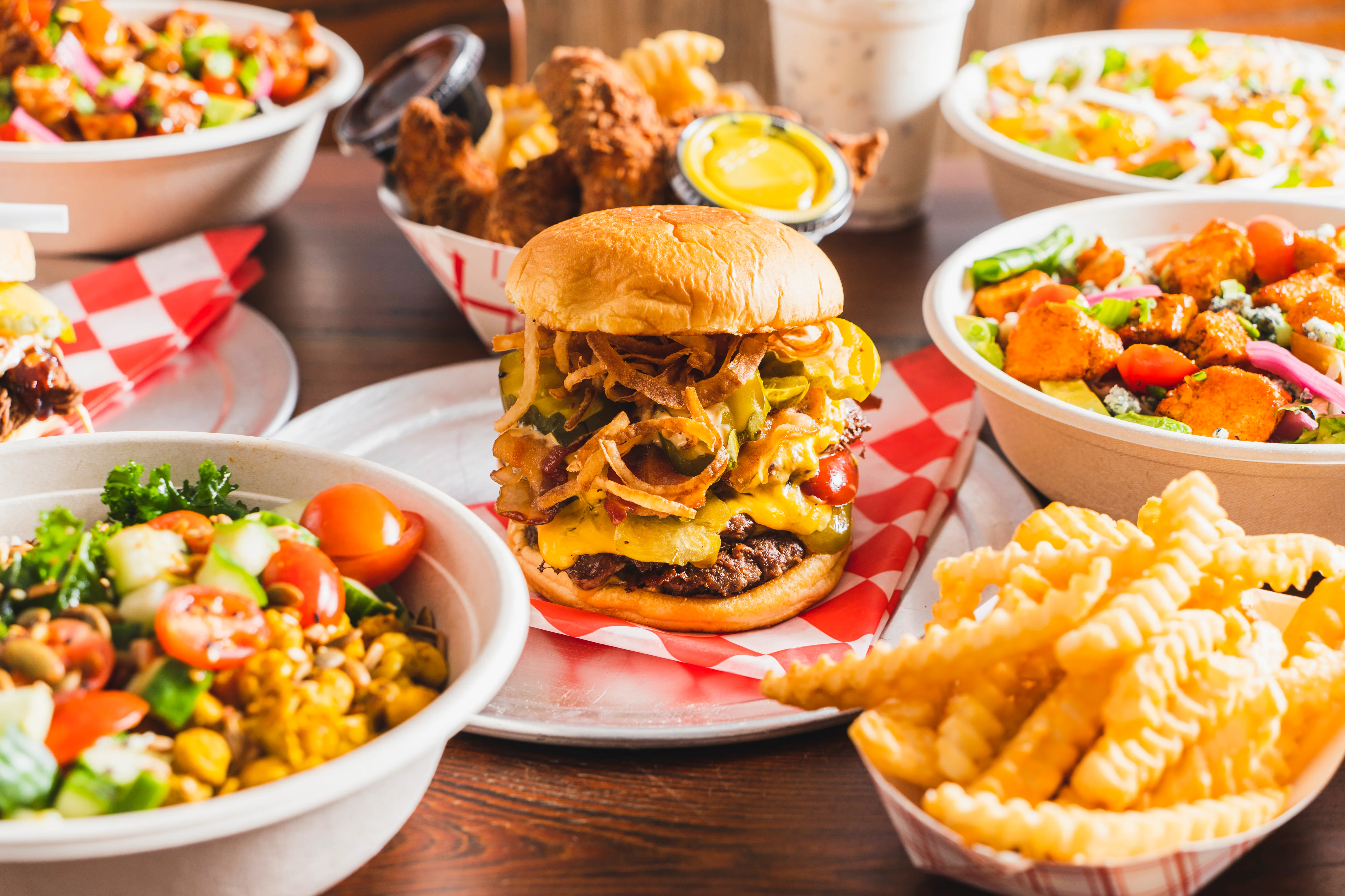 Juicy cheeseburger with toppings and sides in a casual dining setting