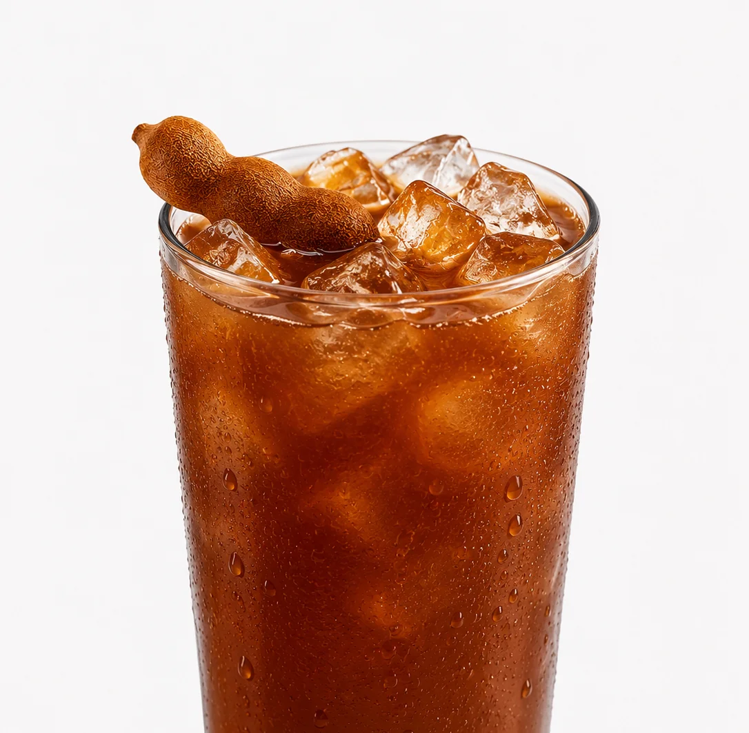Refreshing tamarind soda with ice in a glass