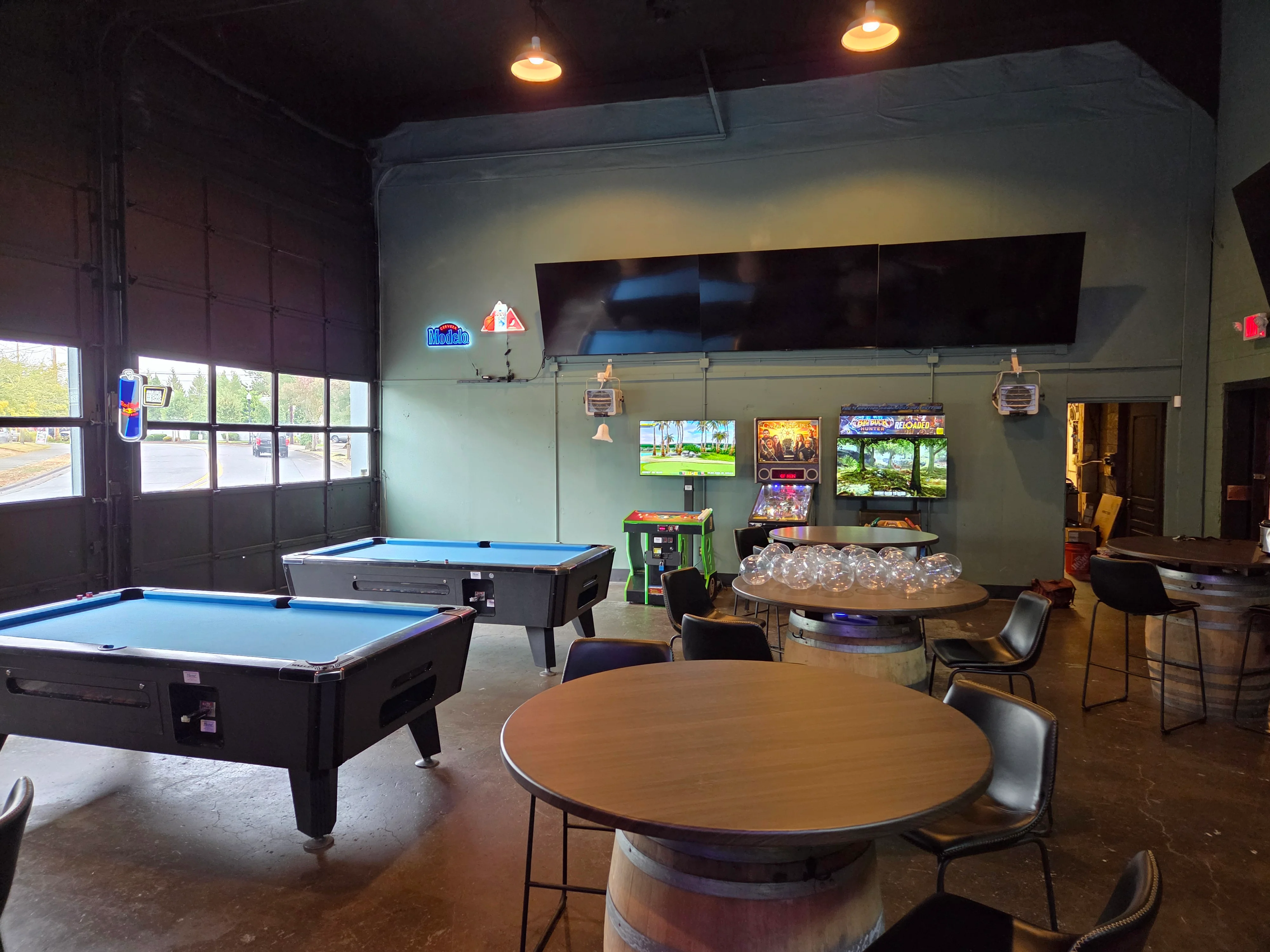 Casual dining area with pool tables and arcade games