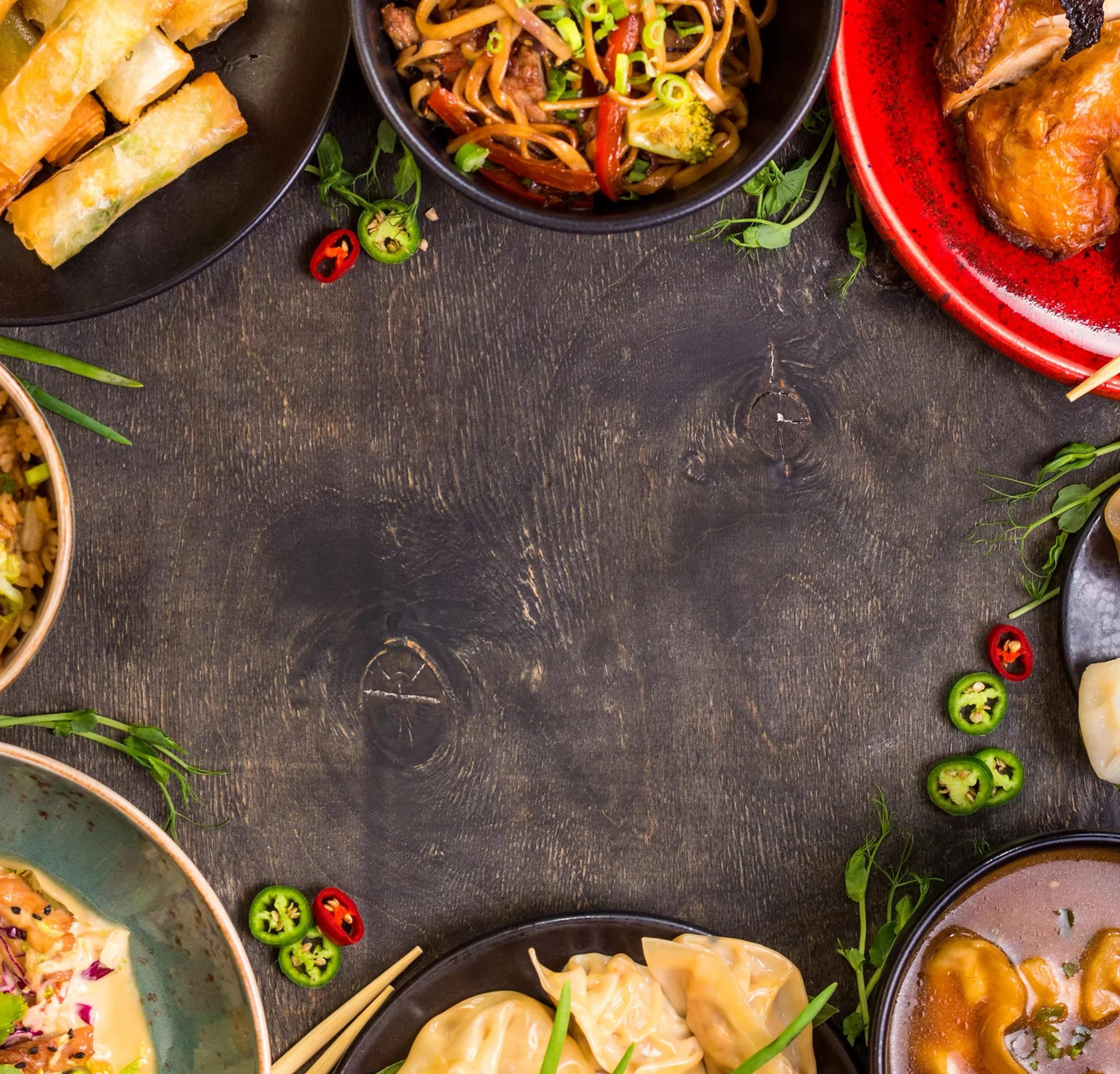 Assorted Asian dishes including dumplings and stir-fried noodles