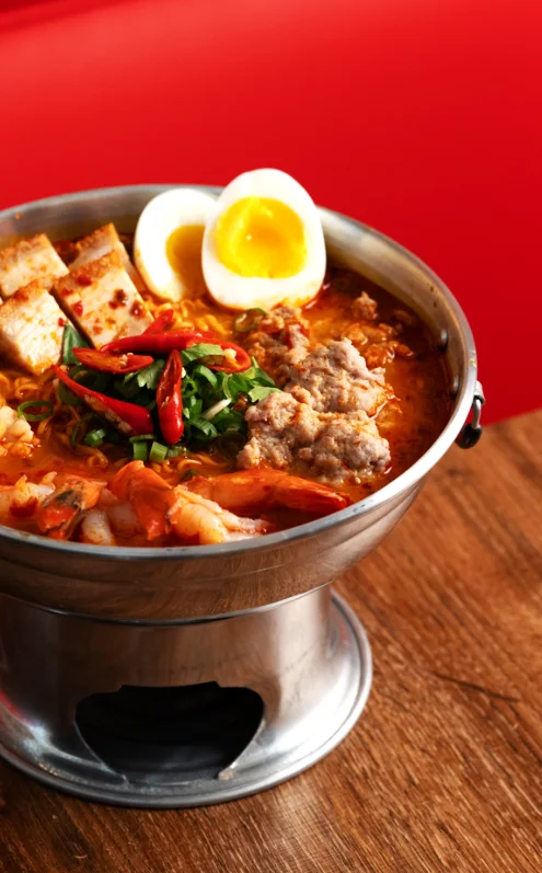Spicy Thai tom yum seafood soup with fresh herbs