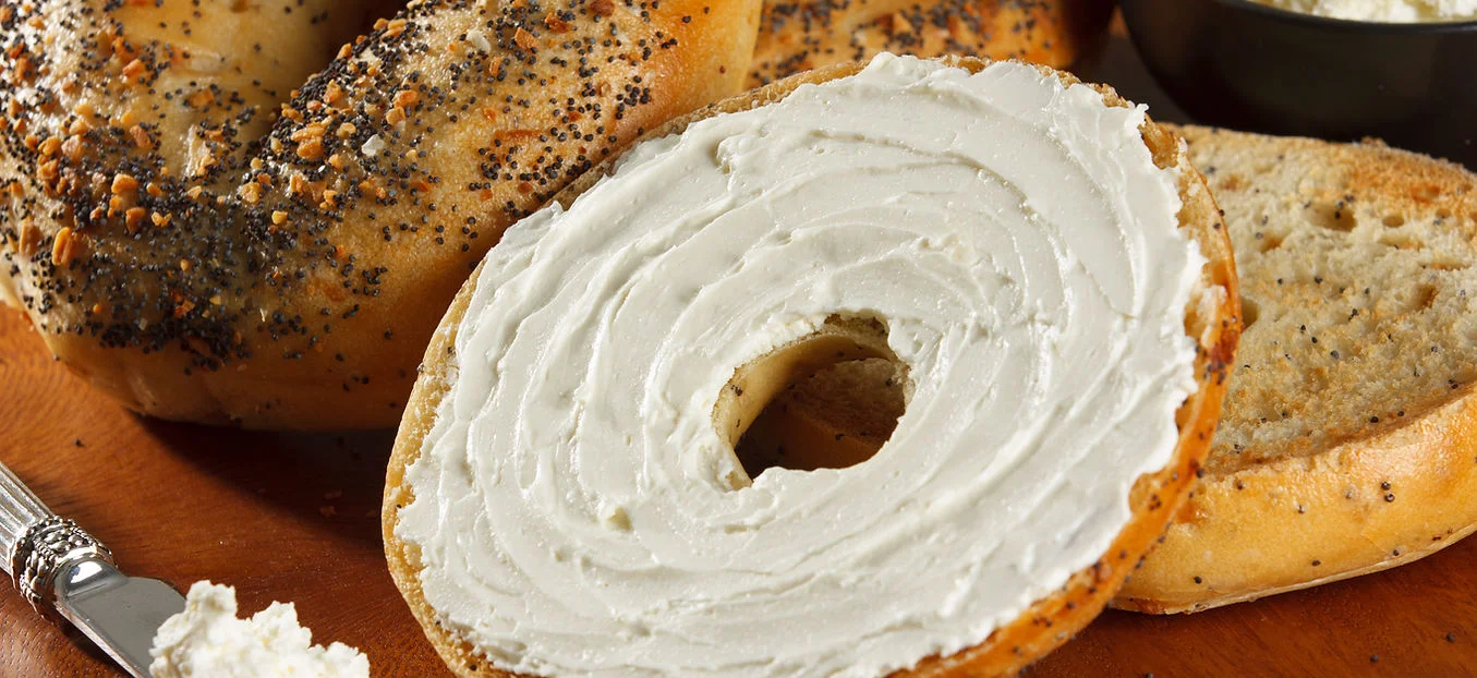Freshly toasted bagel with cream cheese spread