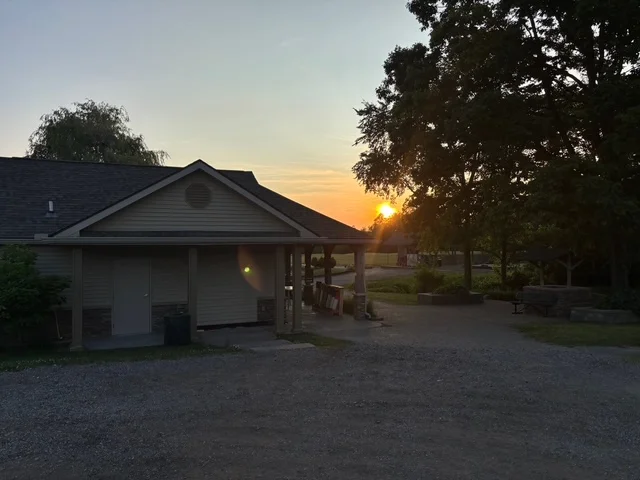 Sunset view over a rustic building in a park setting