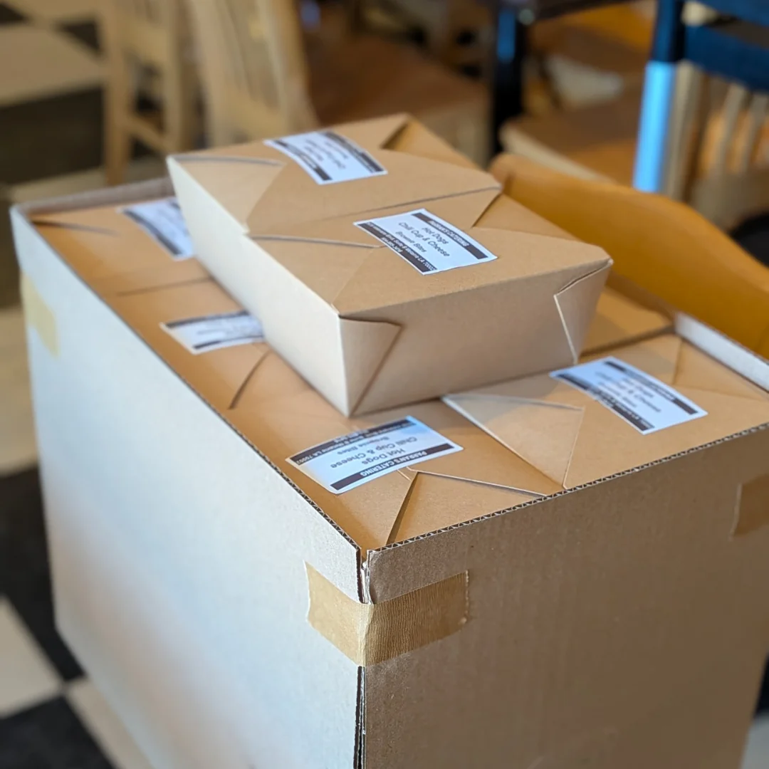 Stacked takeout boxes ready for delivery in a restaurant