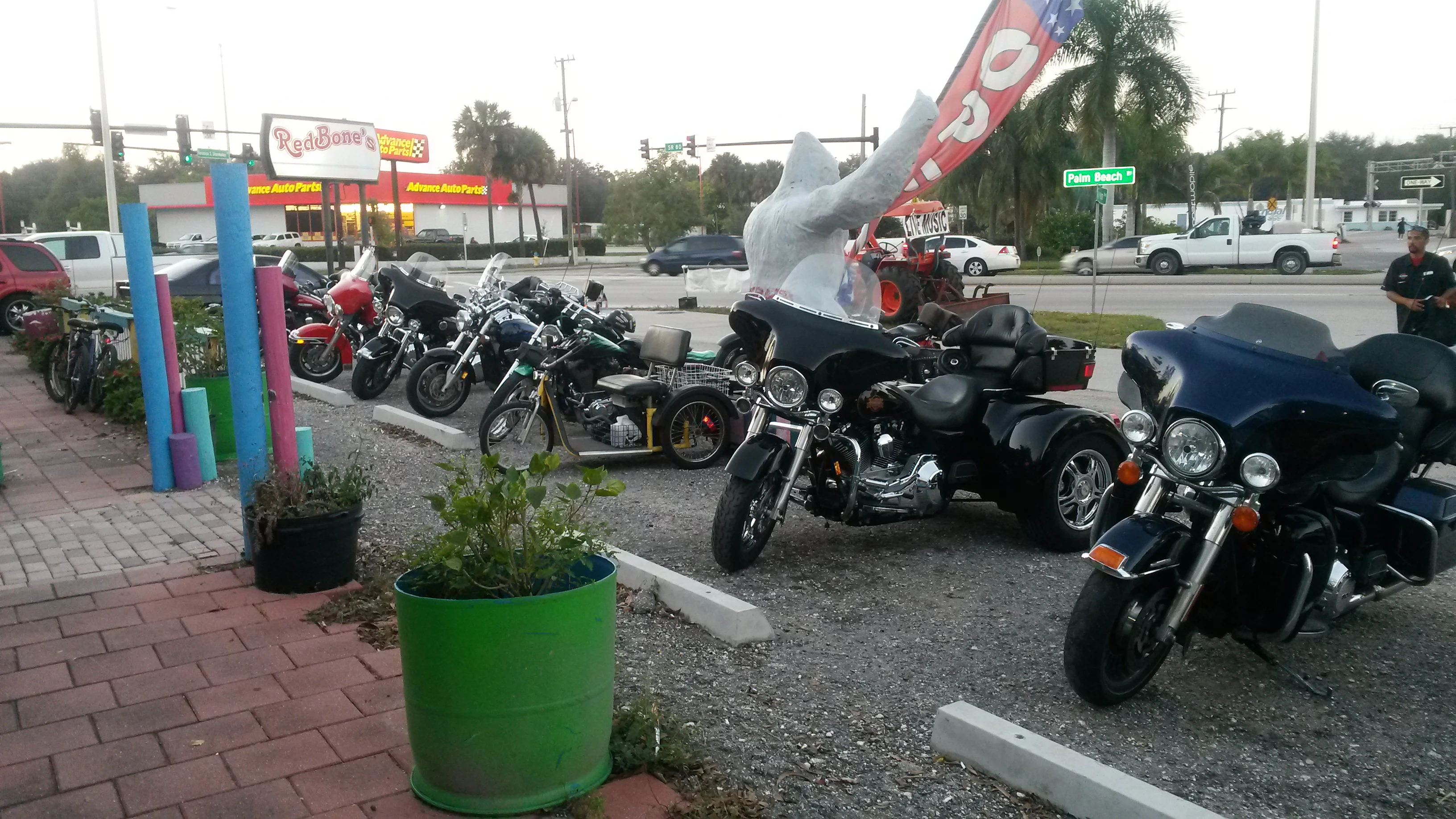 Motorcycles parked outside a vibrant restaurant with colorful decor