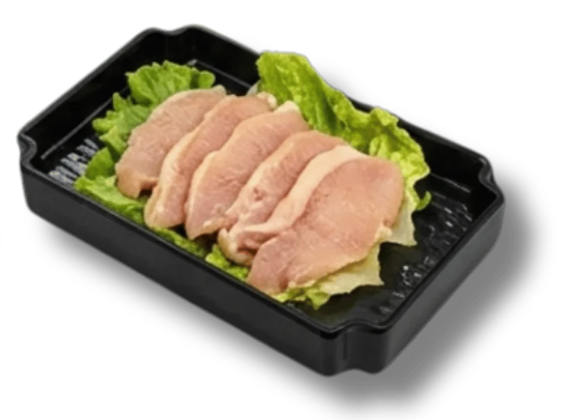 Sliced chicken breast on lettuce in a black tray