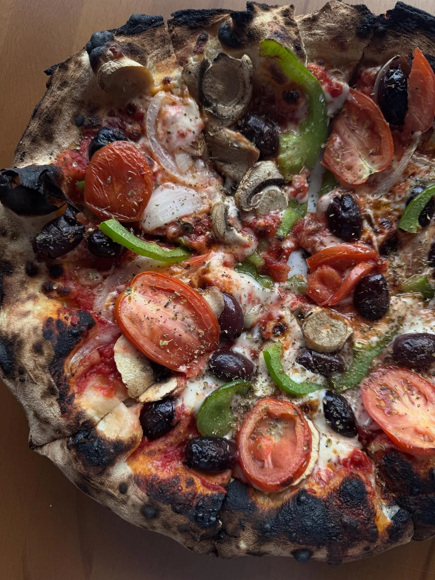 Vegetarian pizza with fresh toppings from a wood-fired oven