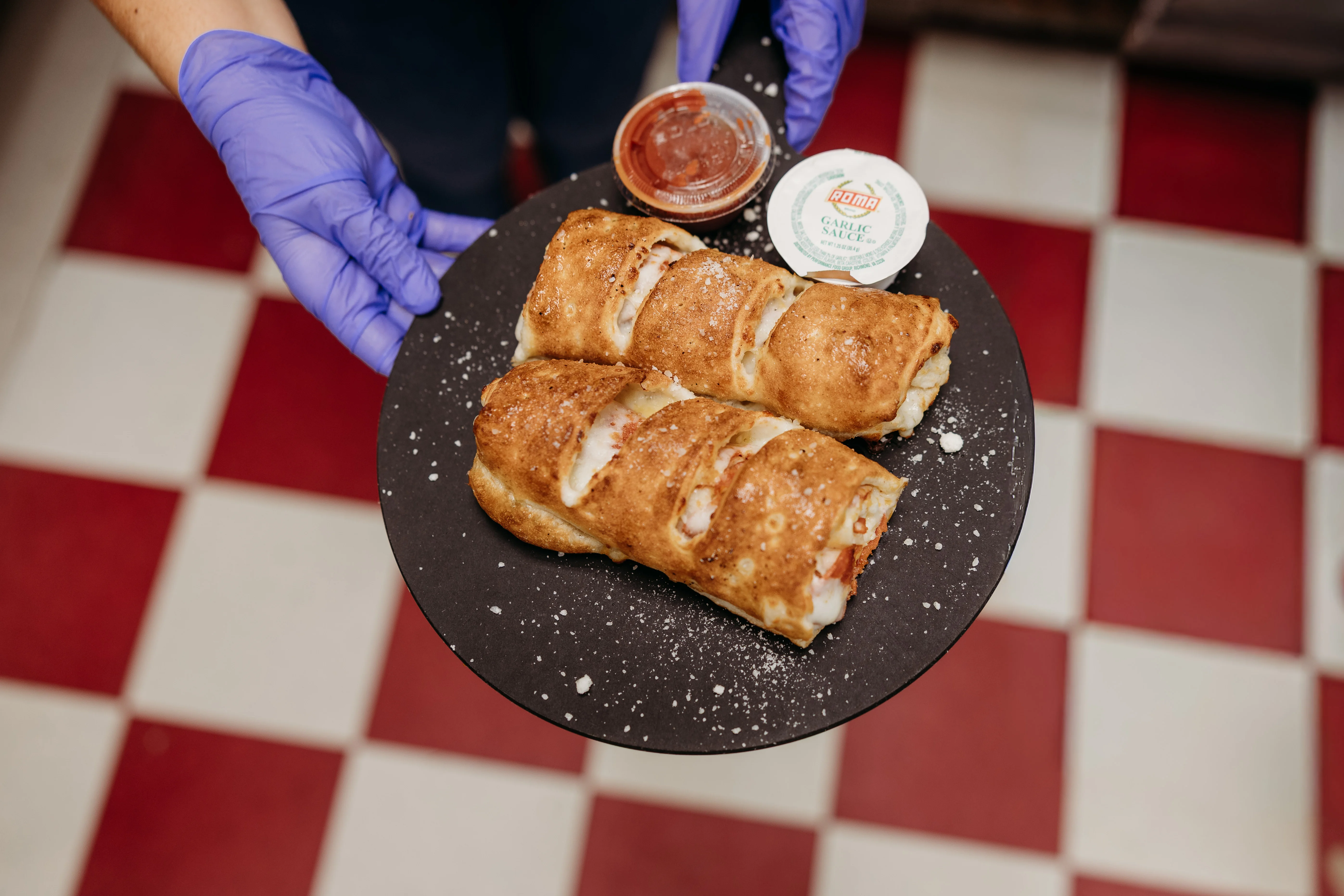 Golden-brown calzones served with dipping sauces