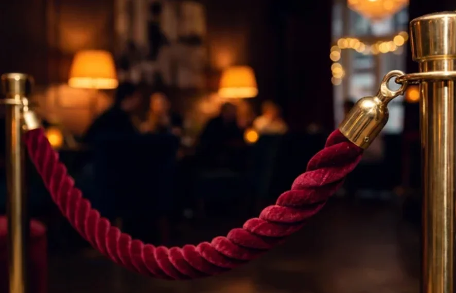 Elegant restaurant entrance with velvet rope and warm lighting