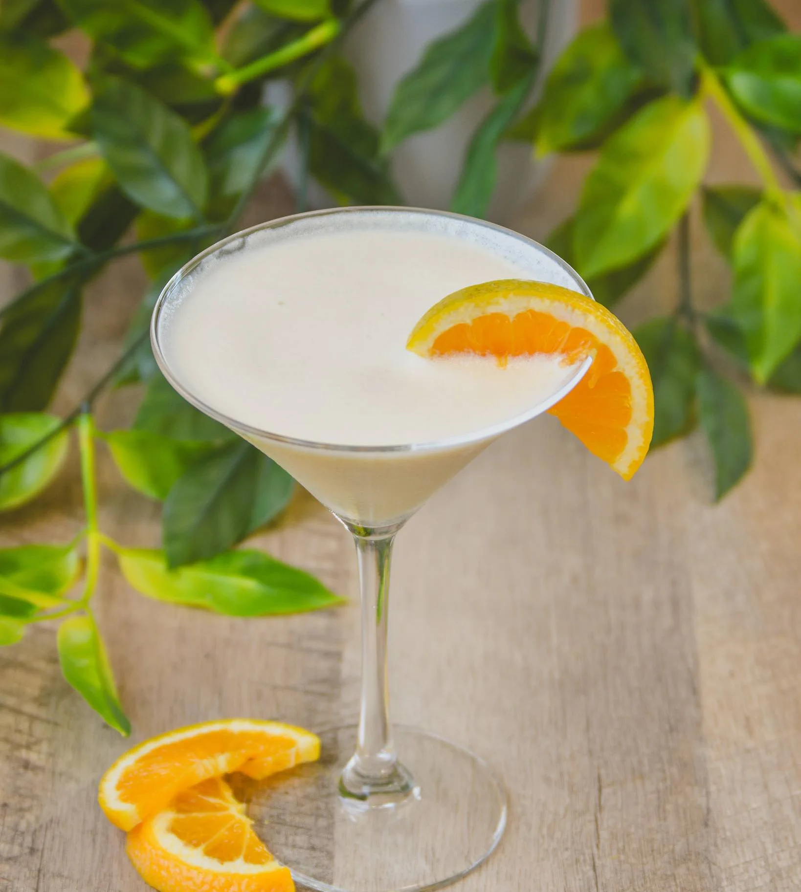Orange Dreamsicle Martini surrounded by orange slices and greenery