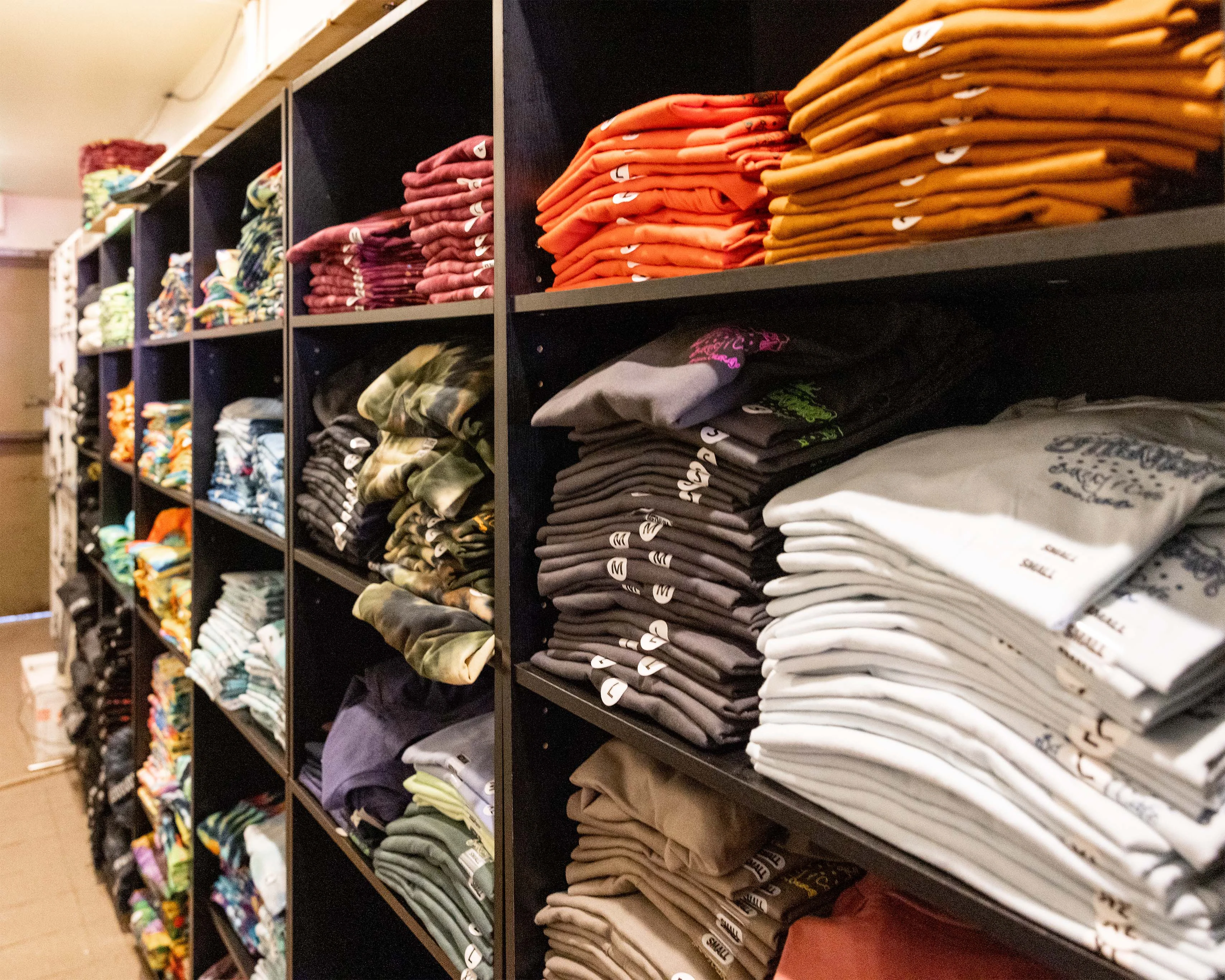Colorful folded clothing displayed on retail shelves