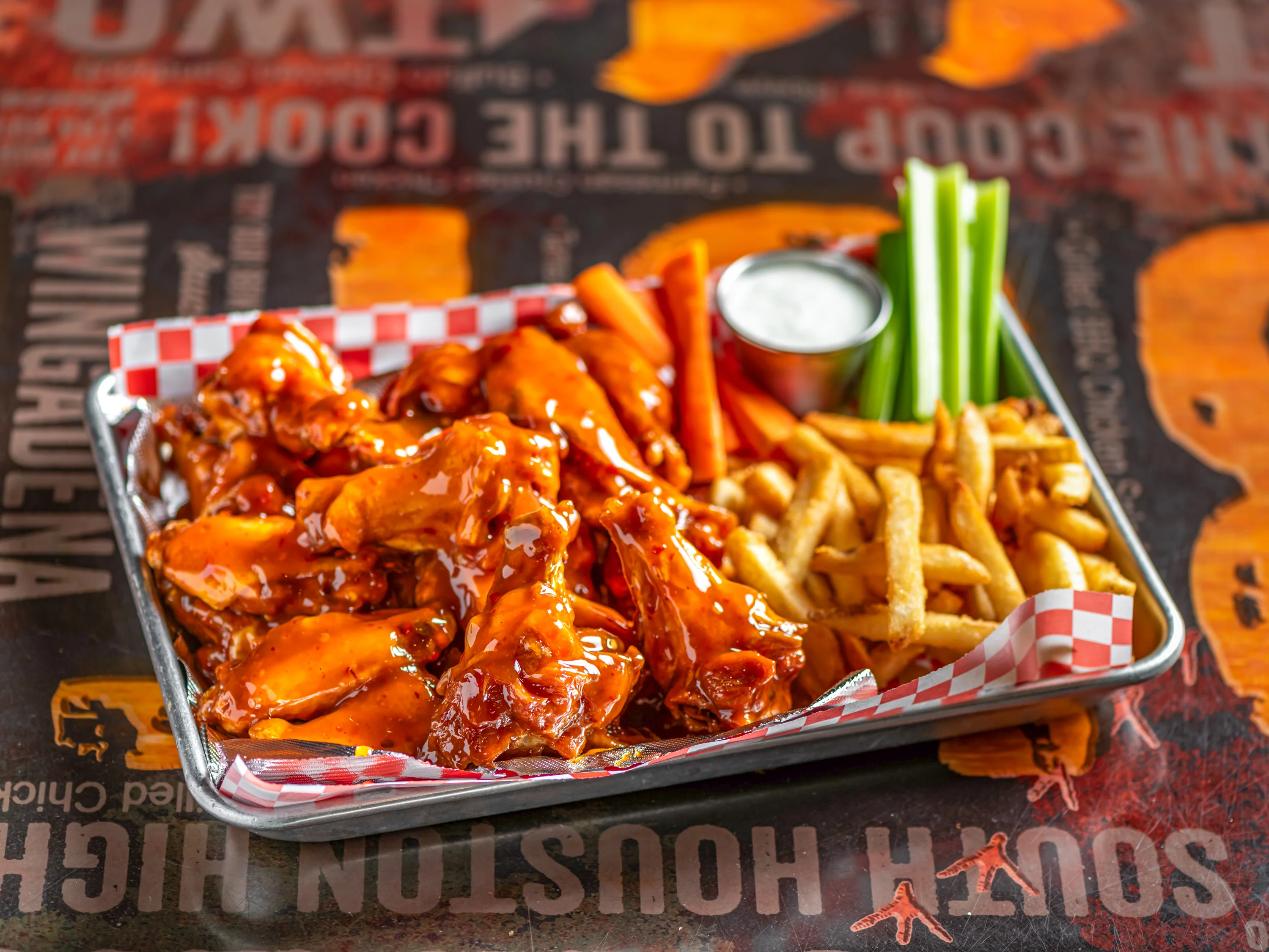 Spicy buffalo chicken wings with fries and celery sticks