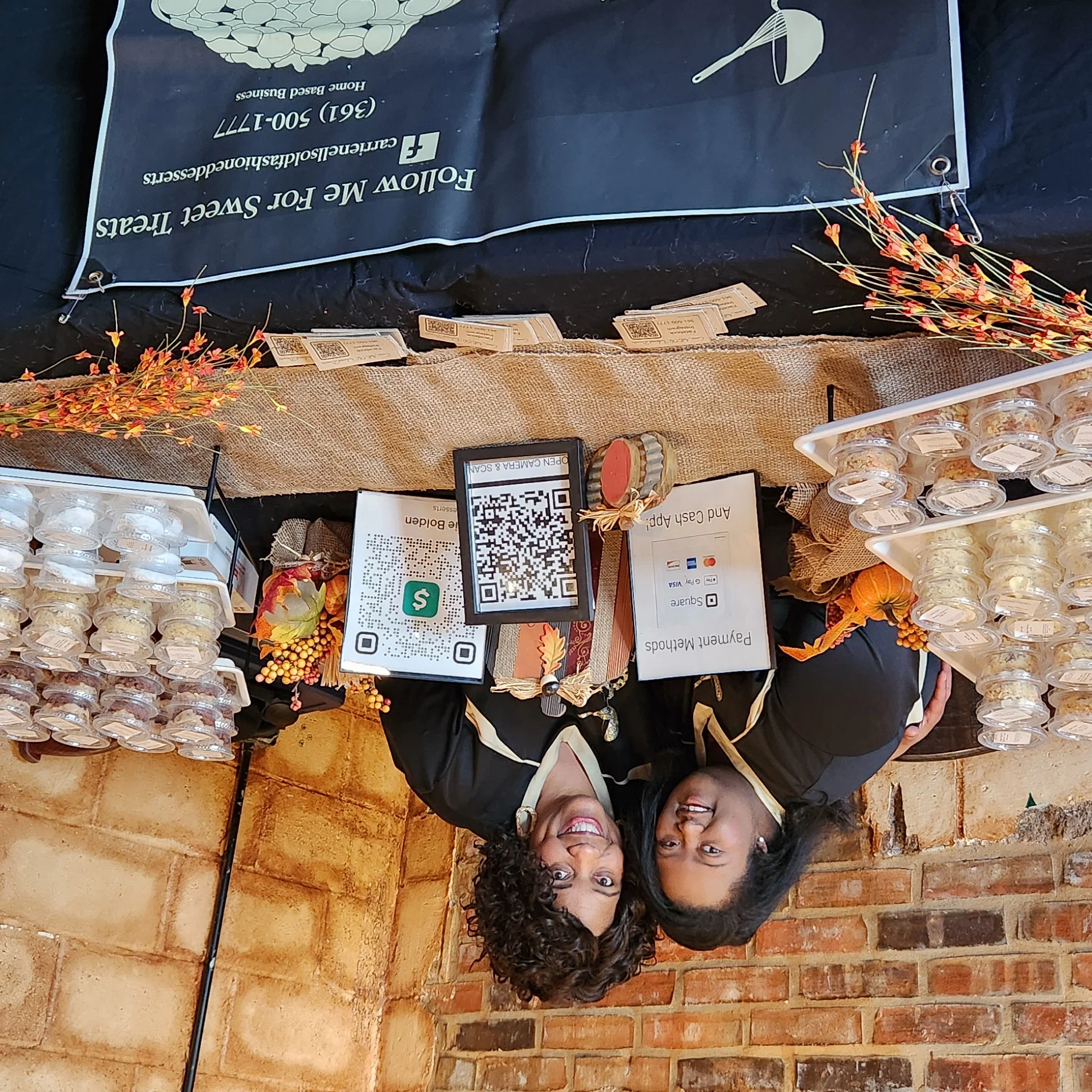 Bakers showcasing homemade desserts at a cozy market stall