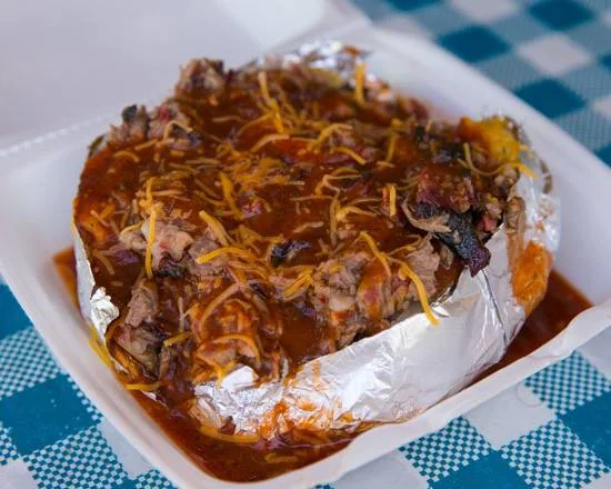 Texas-style loaded baked potato with chili and cheese