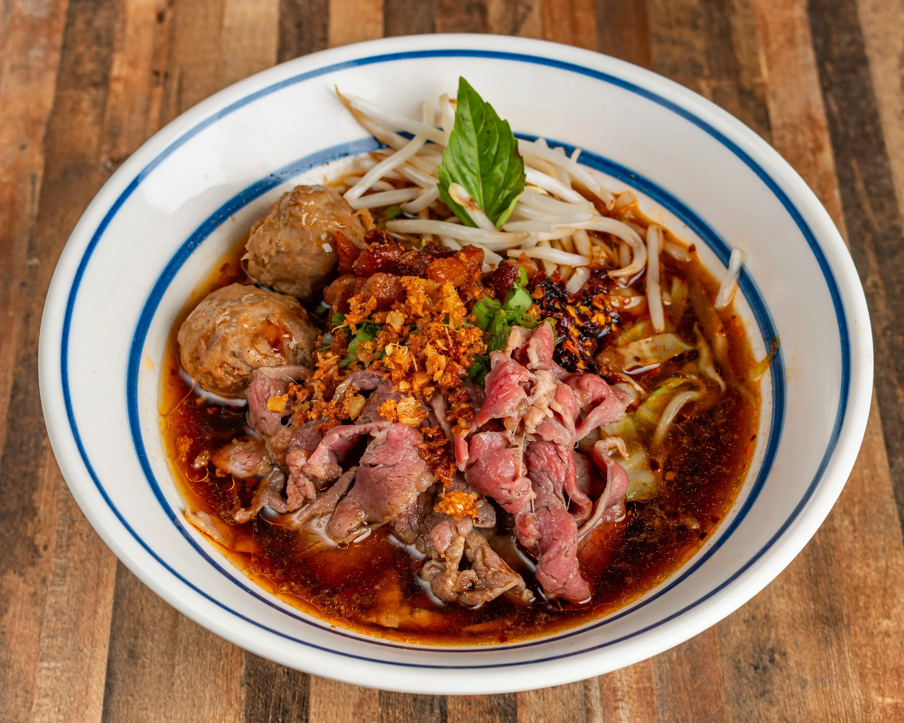 Bowl of Vietnamese pho with beef and herbs