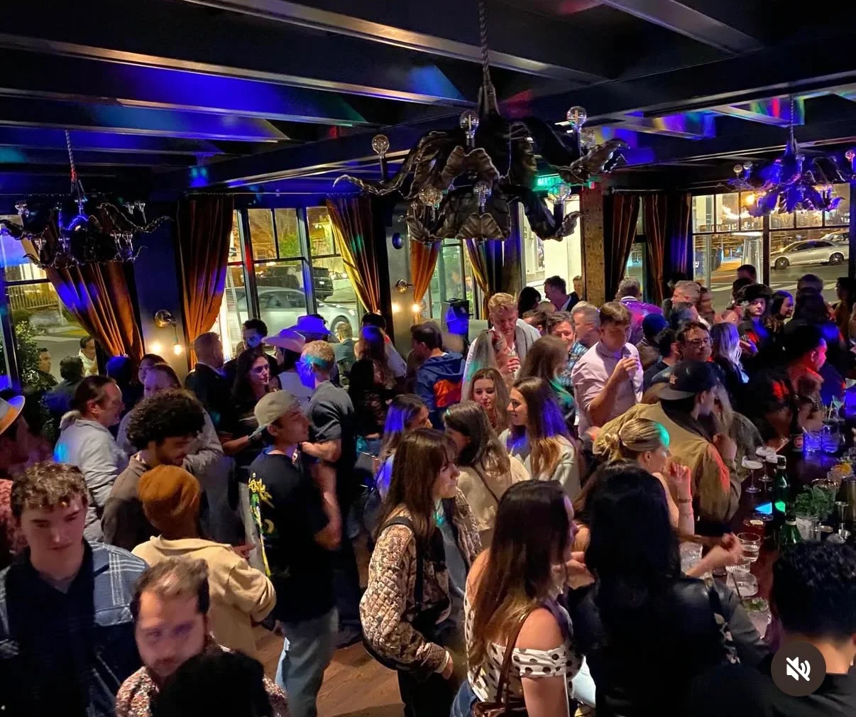 Crowded bar scene with vibrant lighting and lively atmosphere