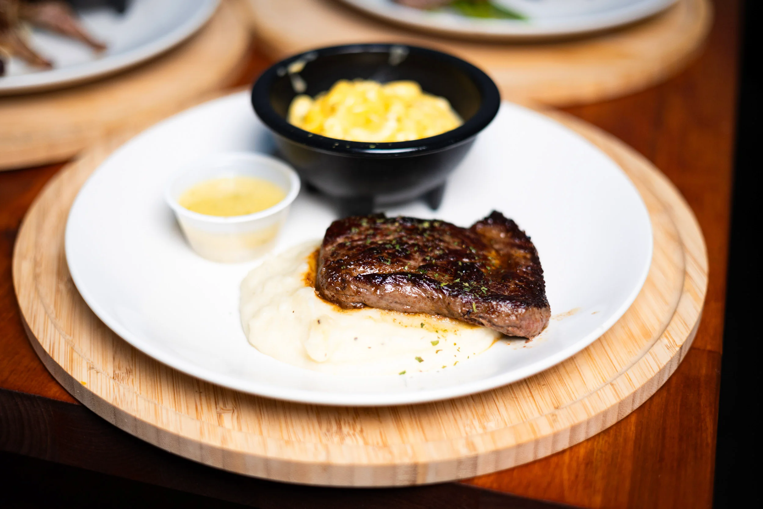 Grilled steak with creamy mashed potatoes and macaroni and cheese