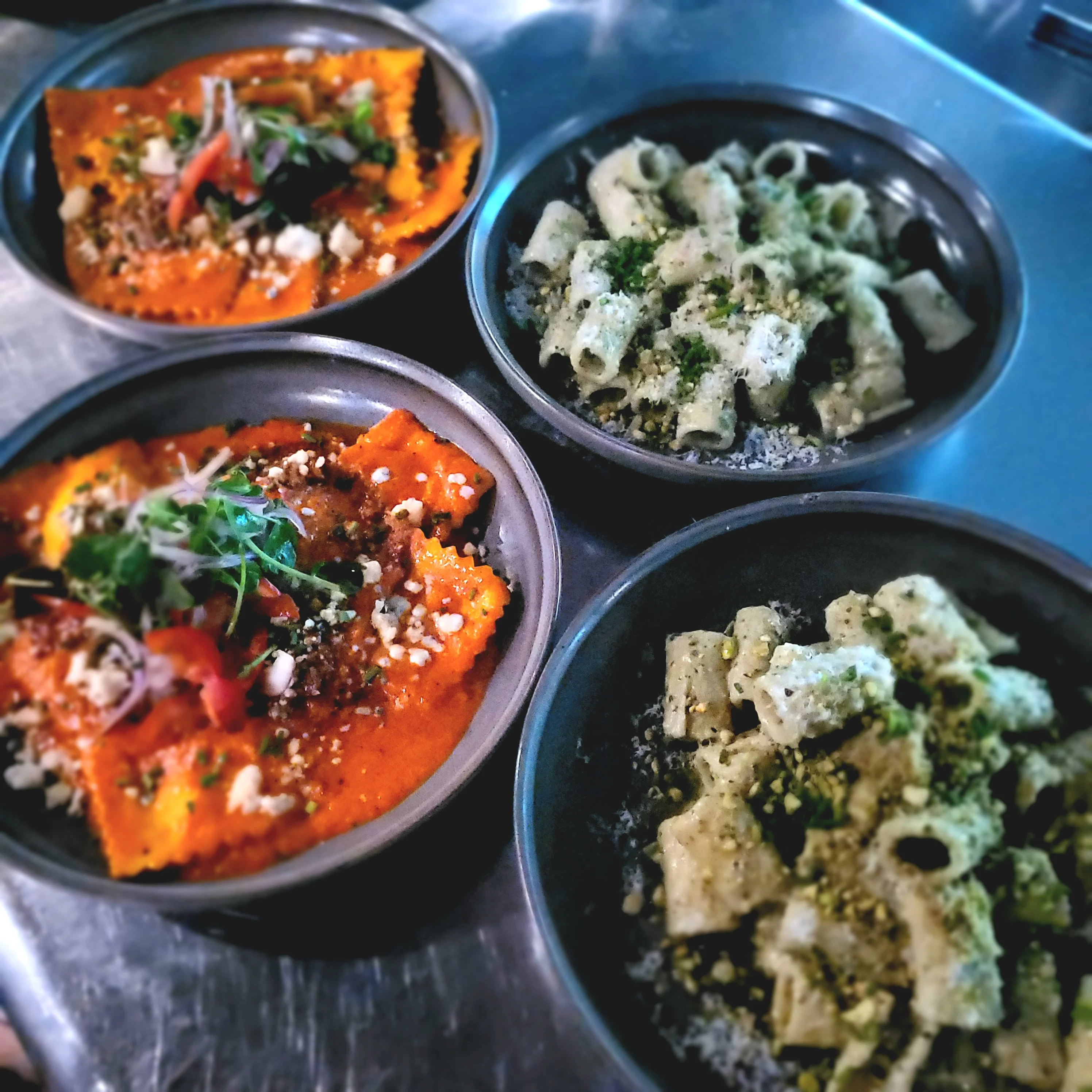 Colorful Italian ravioli and pasta dishes served in bowls