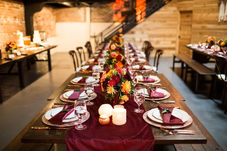 Elegant dining setup with floral centerpieces and warm lighting
