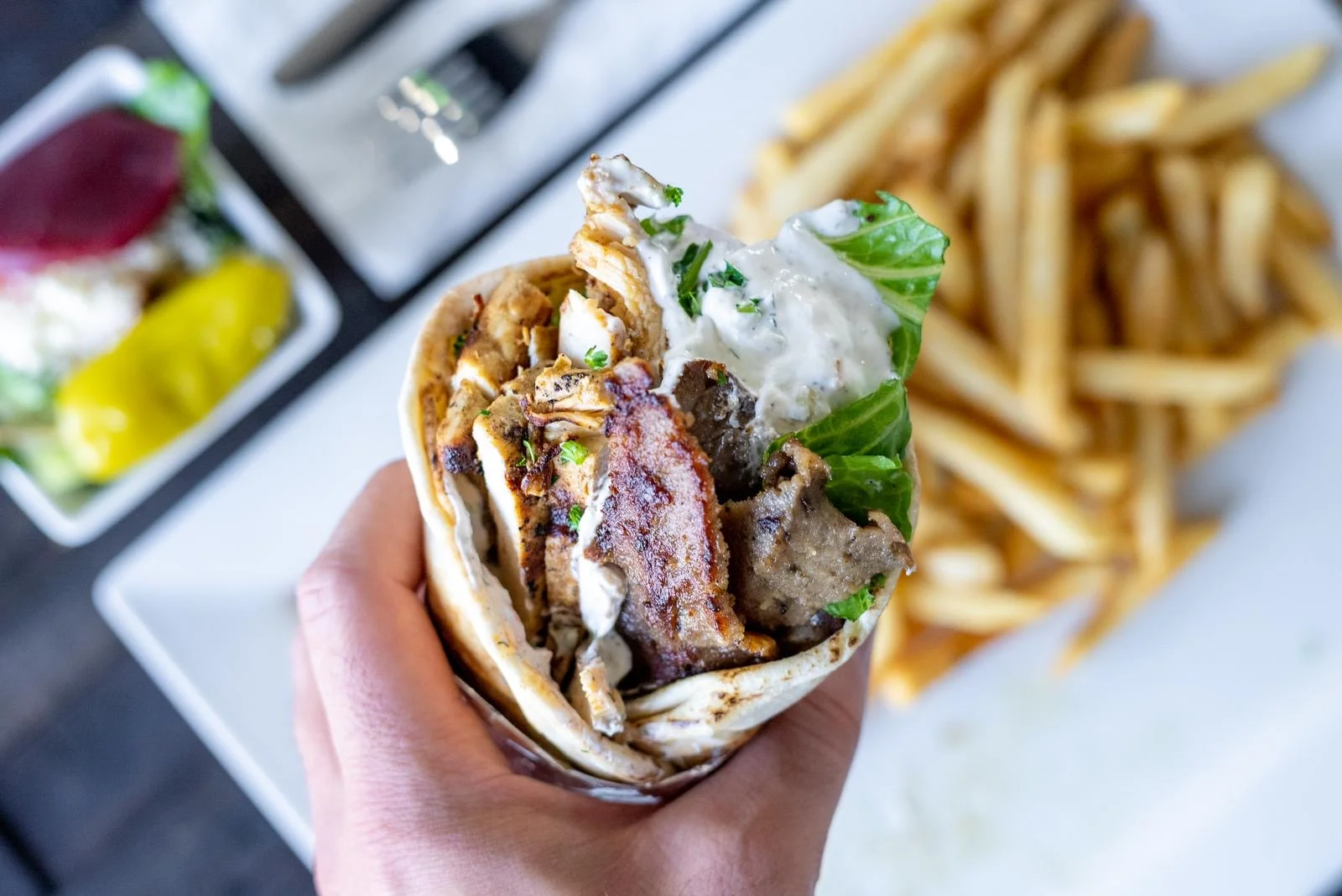 Delicious gourmet burger with fresh toppings on a wooden table