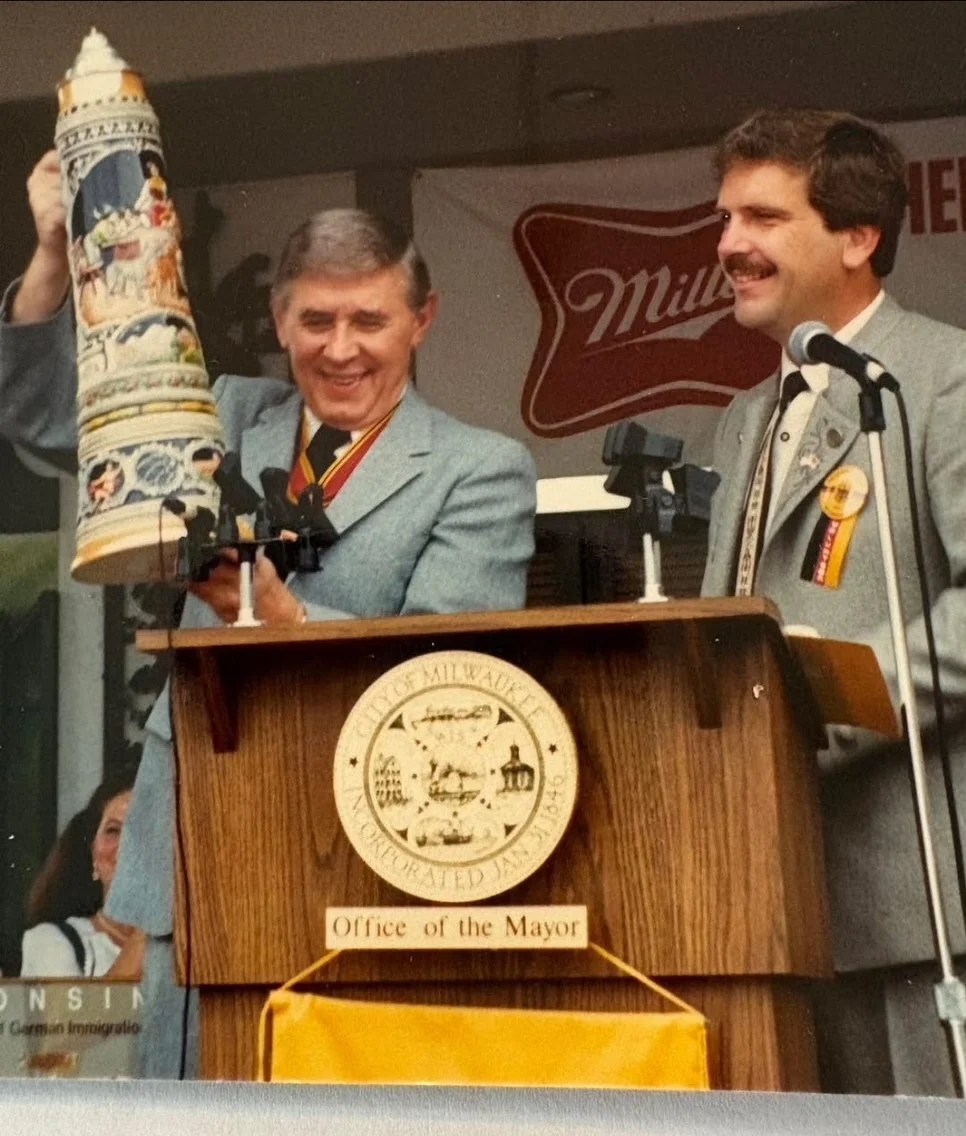 Ceremonial event with officials holding a decorative stein