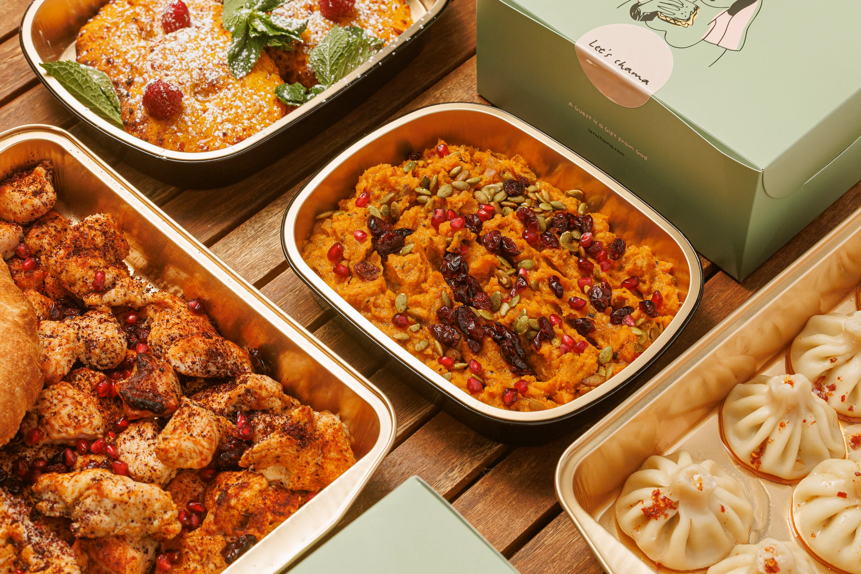 Festive catering spread with roasted chicken, sweet potato mash, dumplings, and dessert