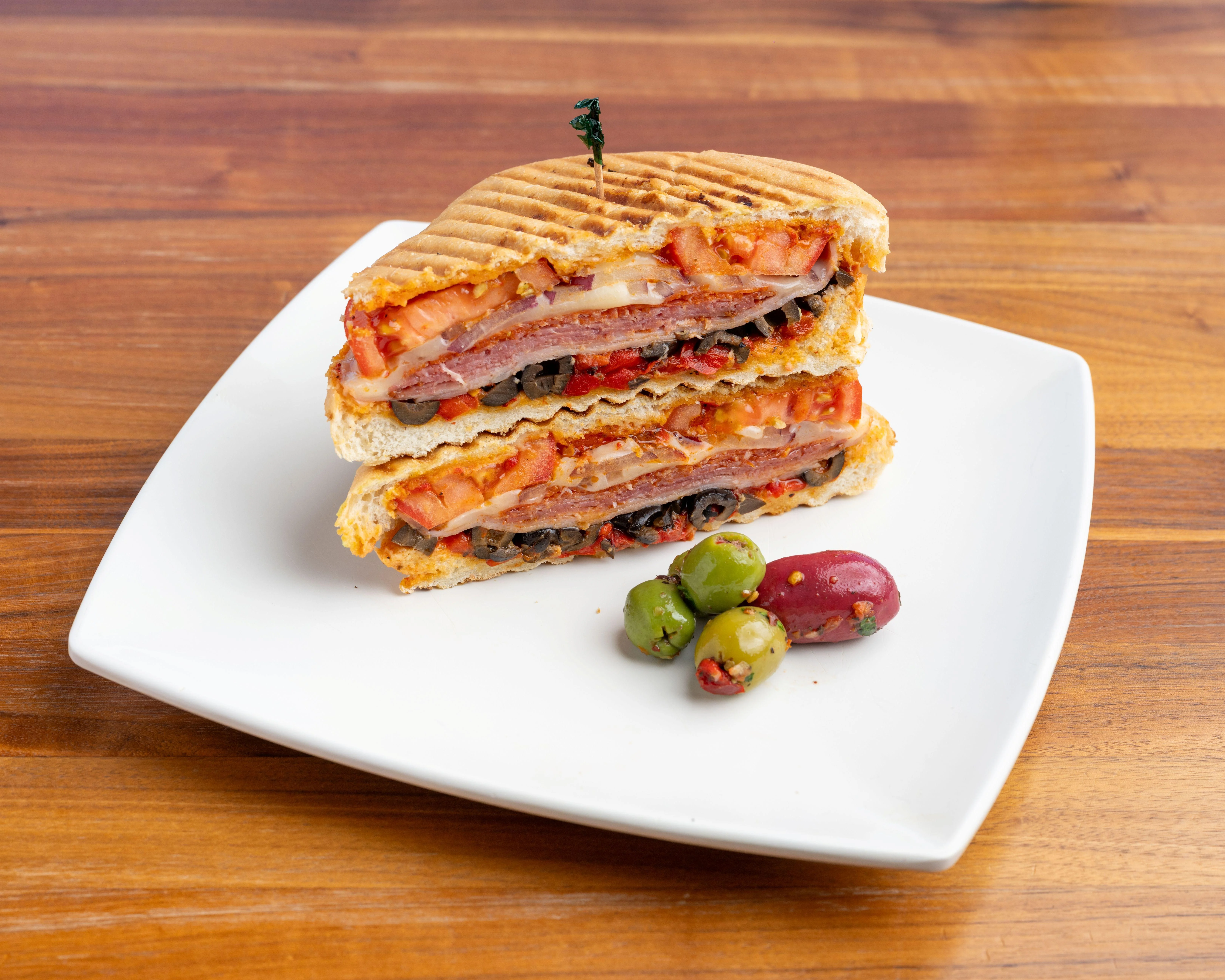 Uncle Carmine Big Italy panini sandwich with italian deli meat and olives
