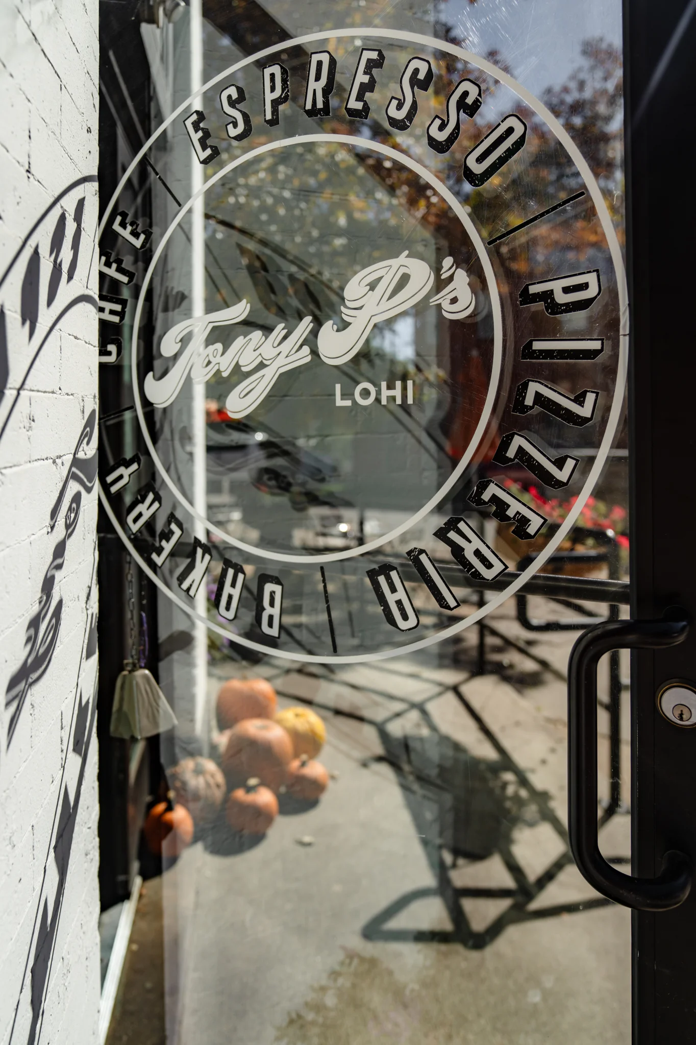 Entrance of Tony P's restaurant showcasing logo and outdoor seating