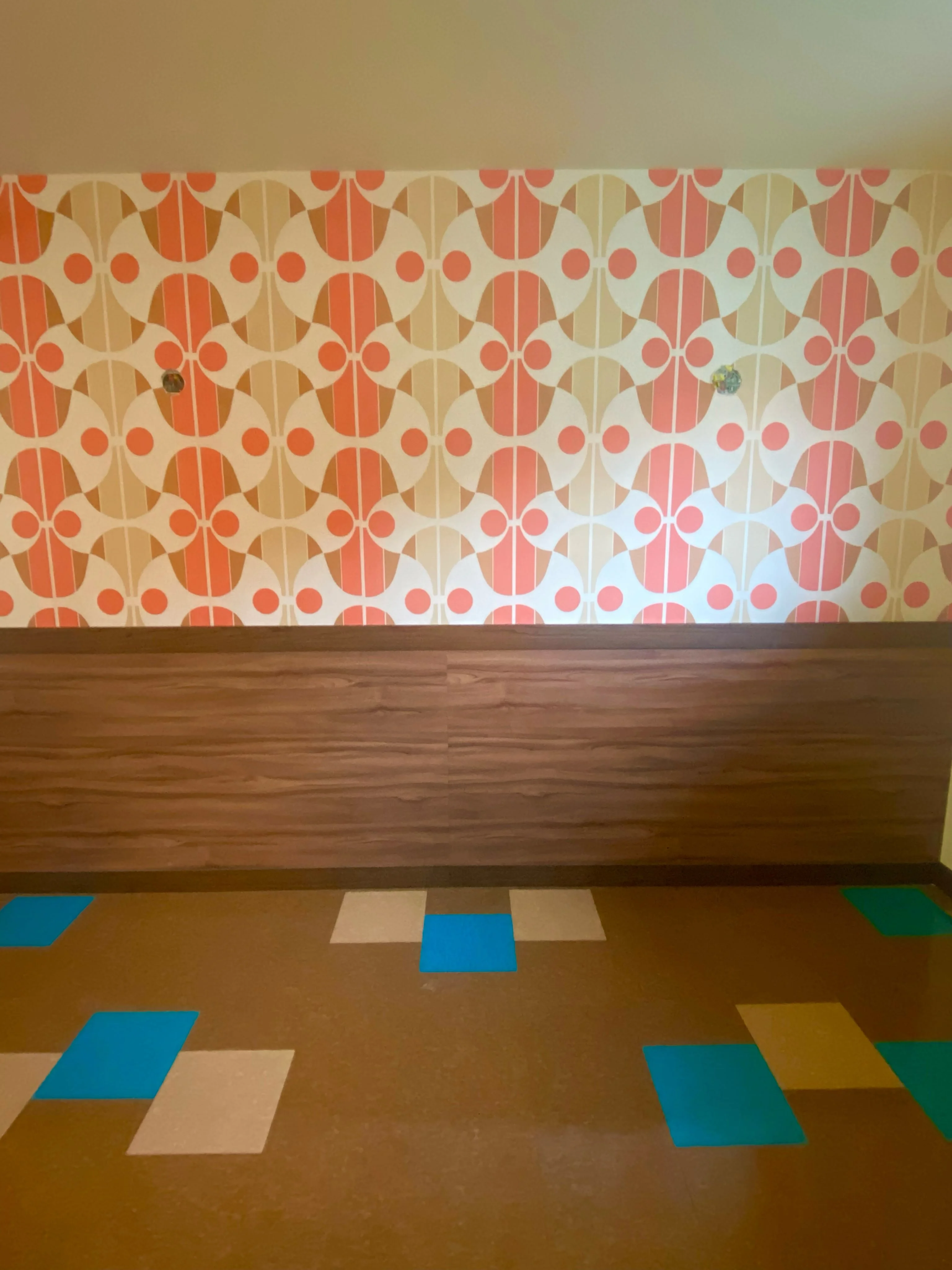 Colorful retro wall design with geometric patterns and wooden paneling