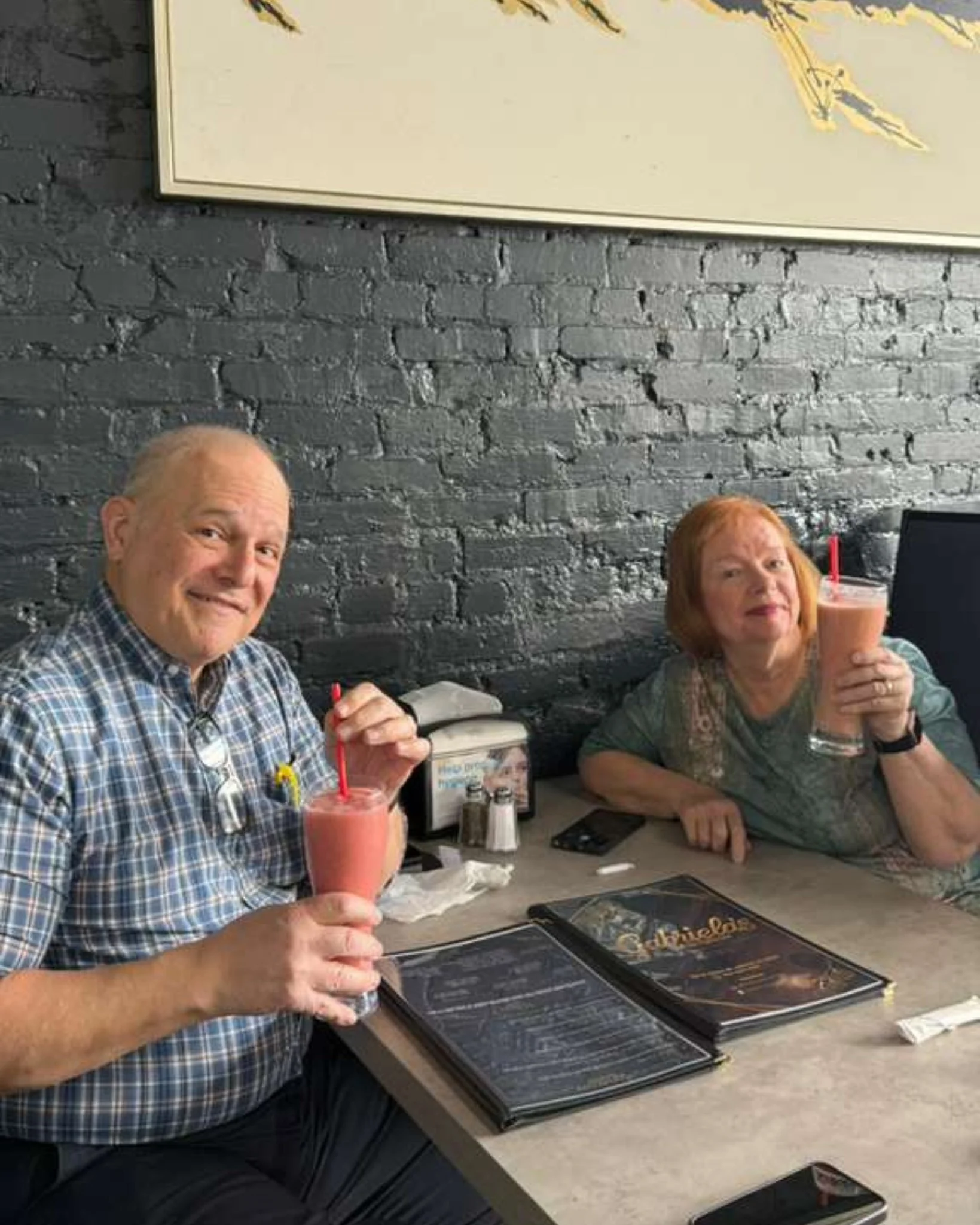 Couple enjoying smoothies in a cozy restaurant setting