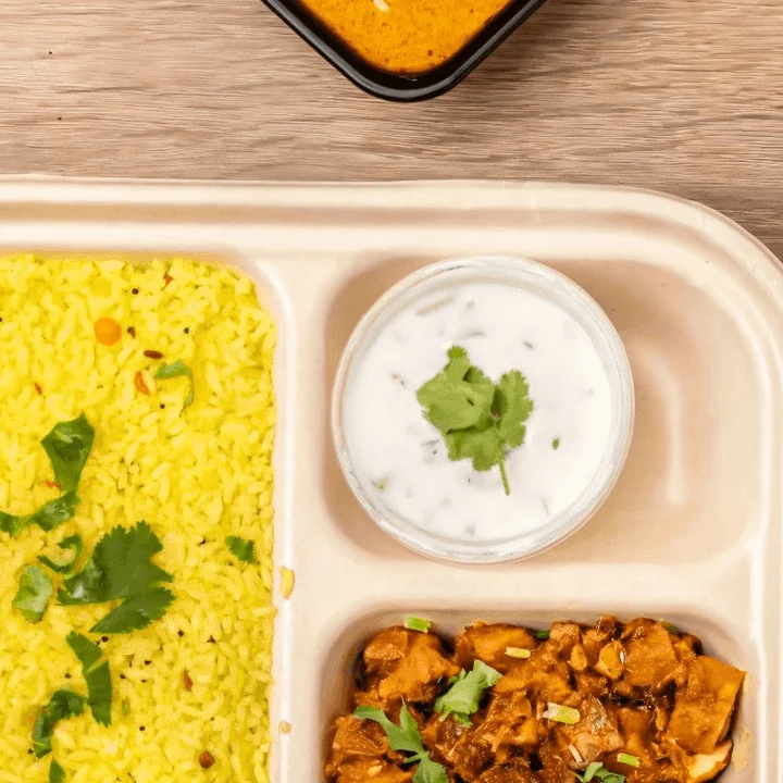 Indian curry meal with rice and yogurt sauce