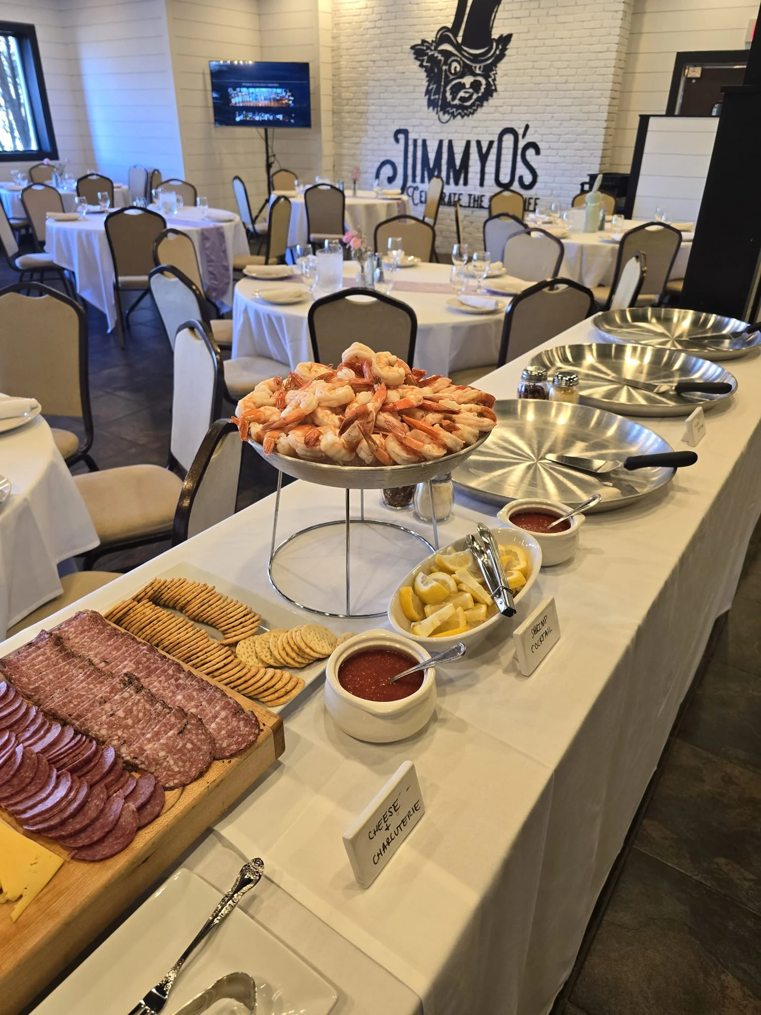 Elegant seafood platter with shrimp and charcuterie in a restaurant setting