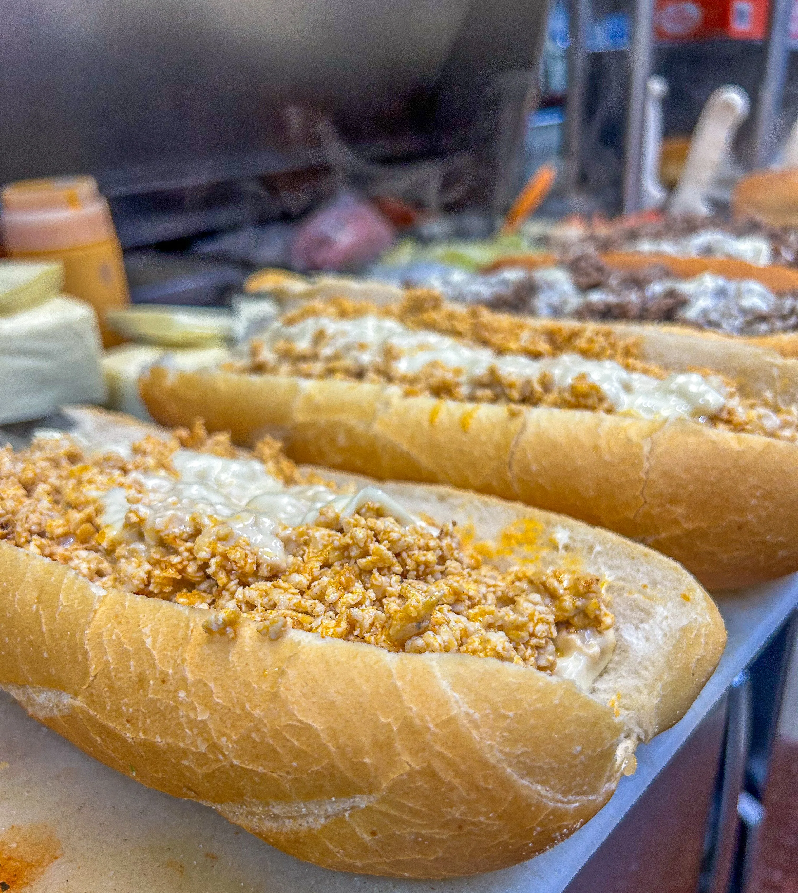 Hoagie roll filled with chopped buffalo chicken, melted cheese, and sauce. Multiple