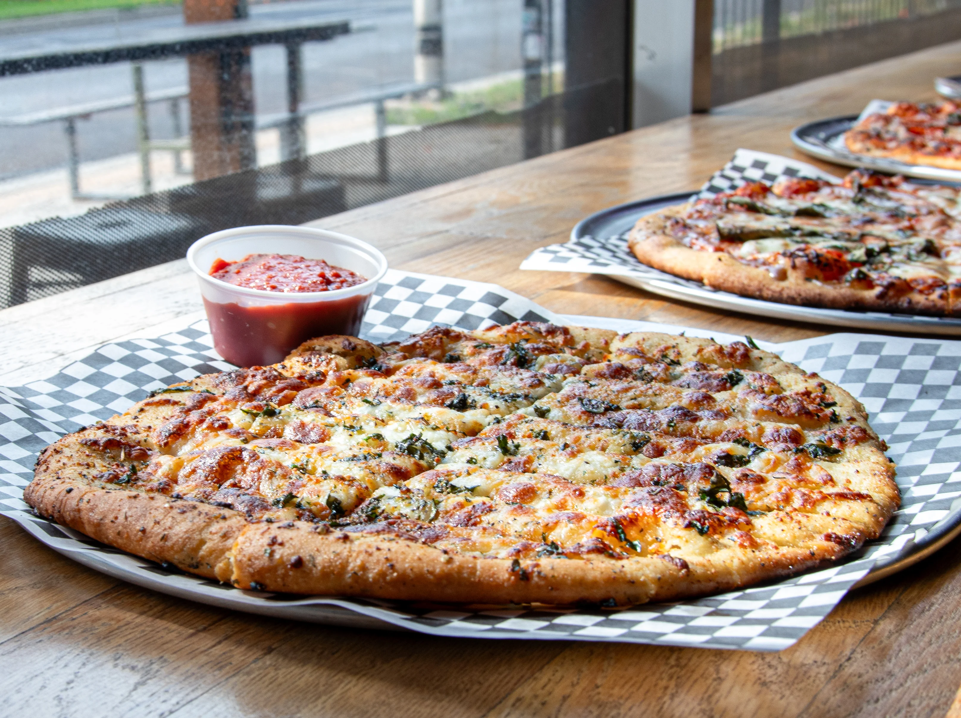 Delicious cheese pizza served with marinara sauce