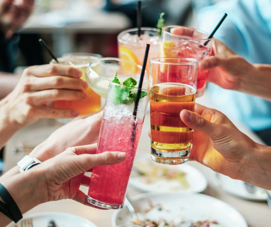 Cheers with colorful cocktails at a lively gathering