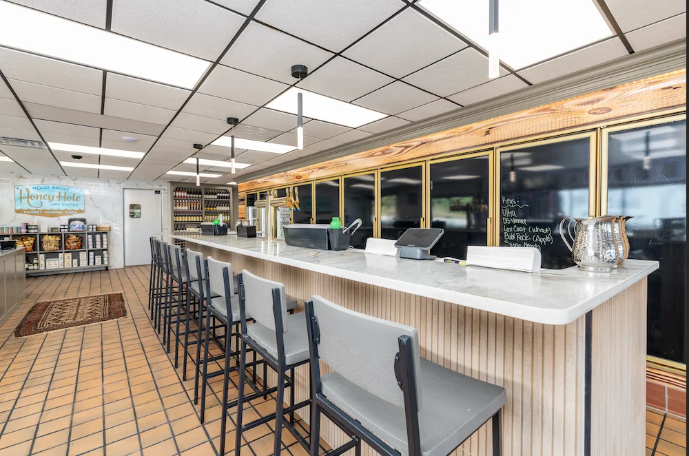 Interior of a modern restaurant with a bar and seating area.