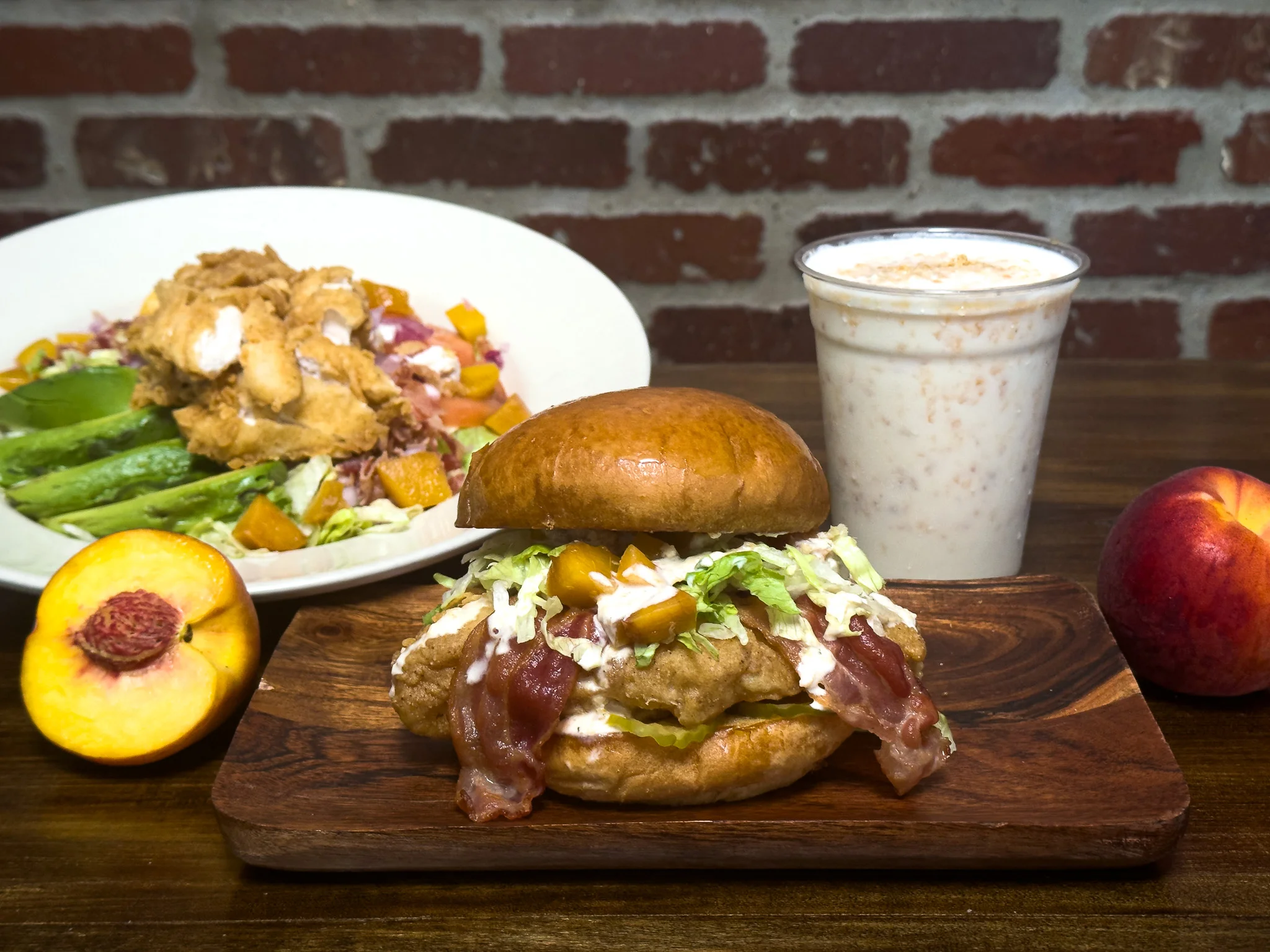 Two gourmet burgers with toppings on a wooden board, served with fries.