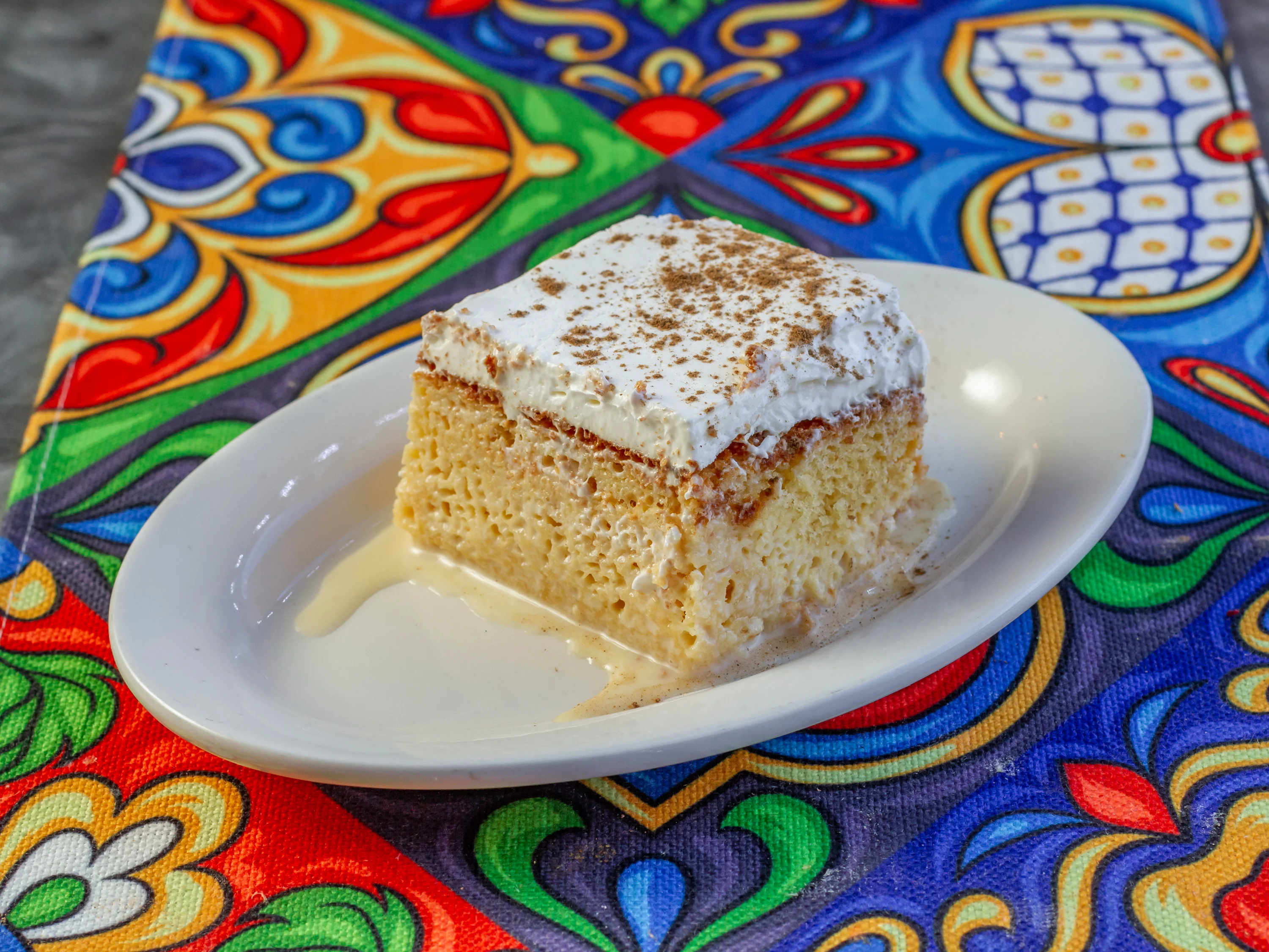 Delicious tres leches cake with whipped cream and cinnamon