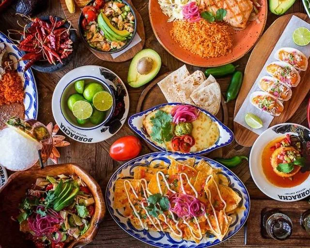 A vibrant spread of colorful Mexican dishes on a table.