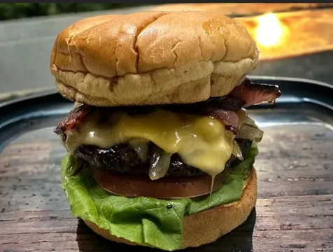 Juicy American cheeseburger with lettuce and bacon
