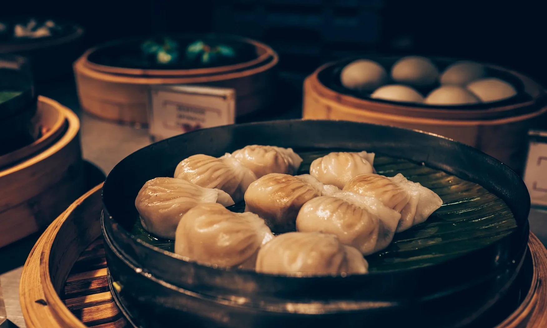 Steamed dim sum dumplings in bamboo steamer