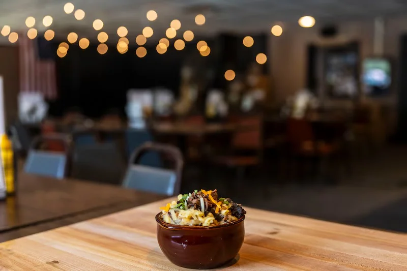 Bowl of mac and cheese topped with brisket