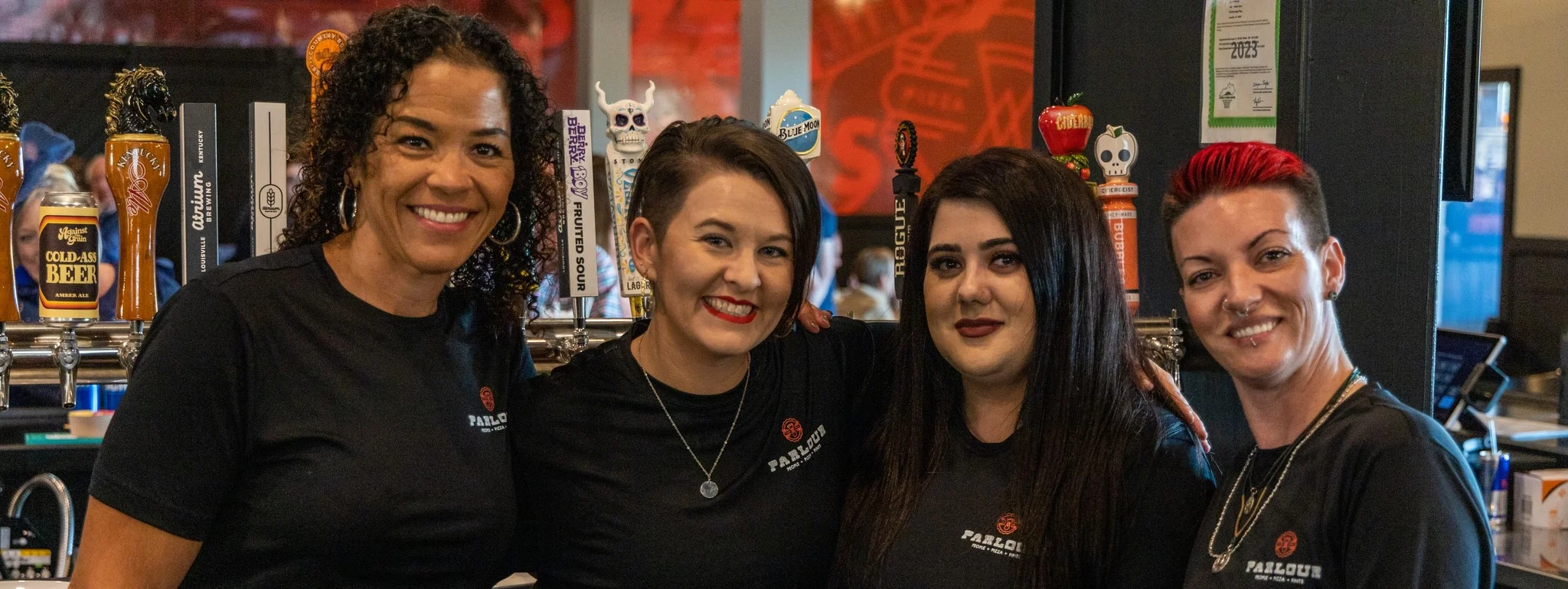 Friendly bartenders at a lively bar counter