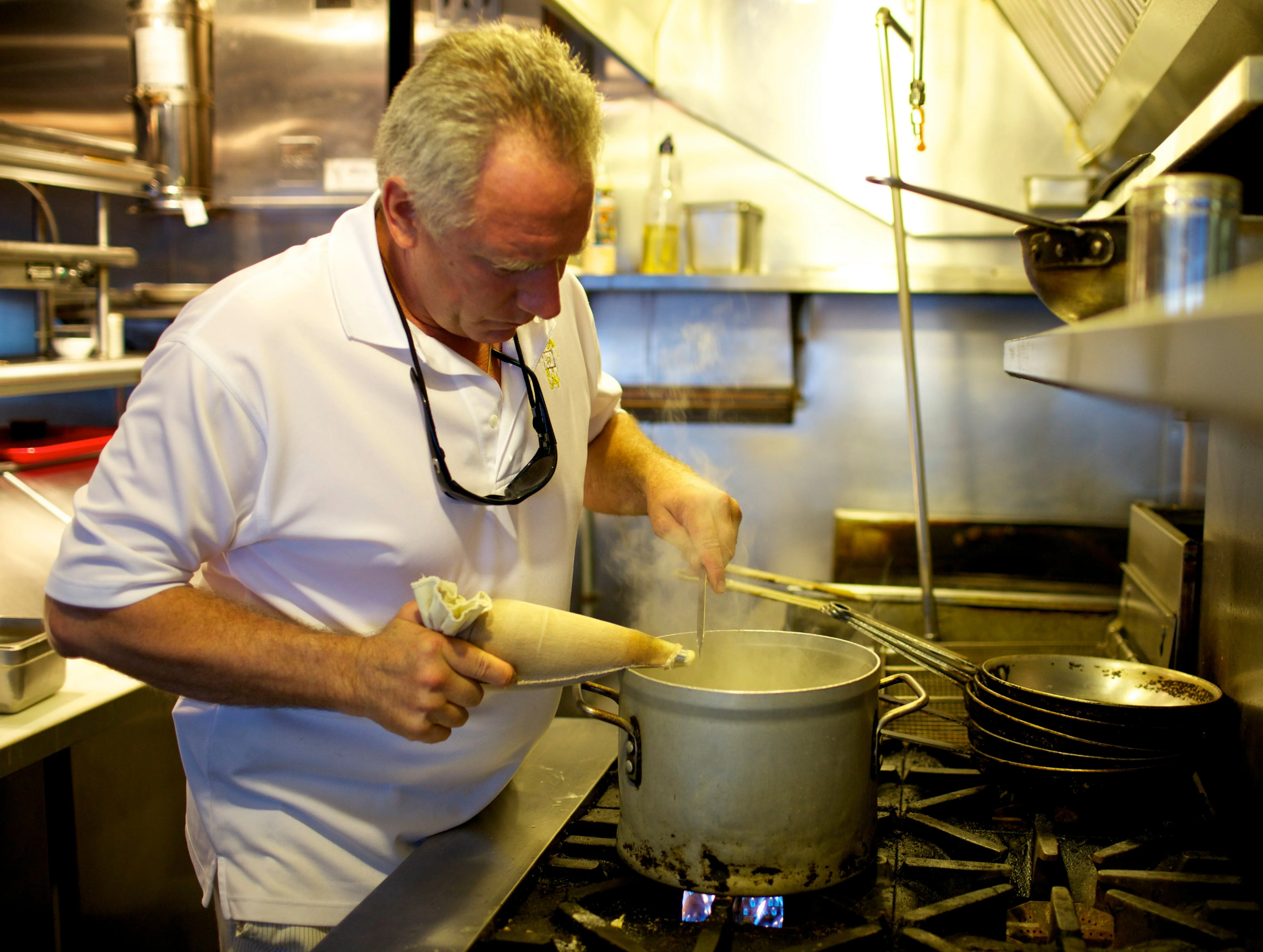 Chef preparing a savory dish in a busy restaurant kitchen