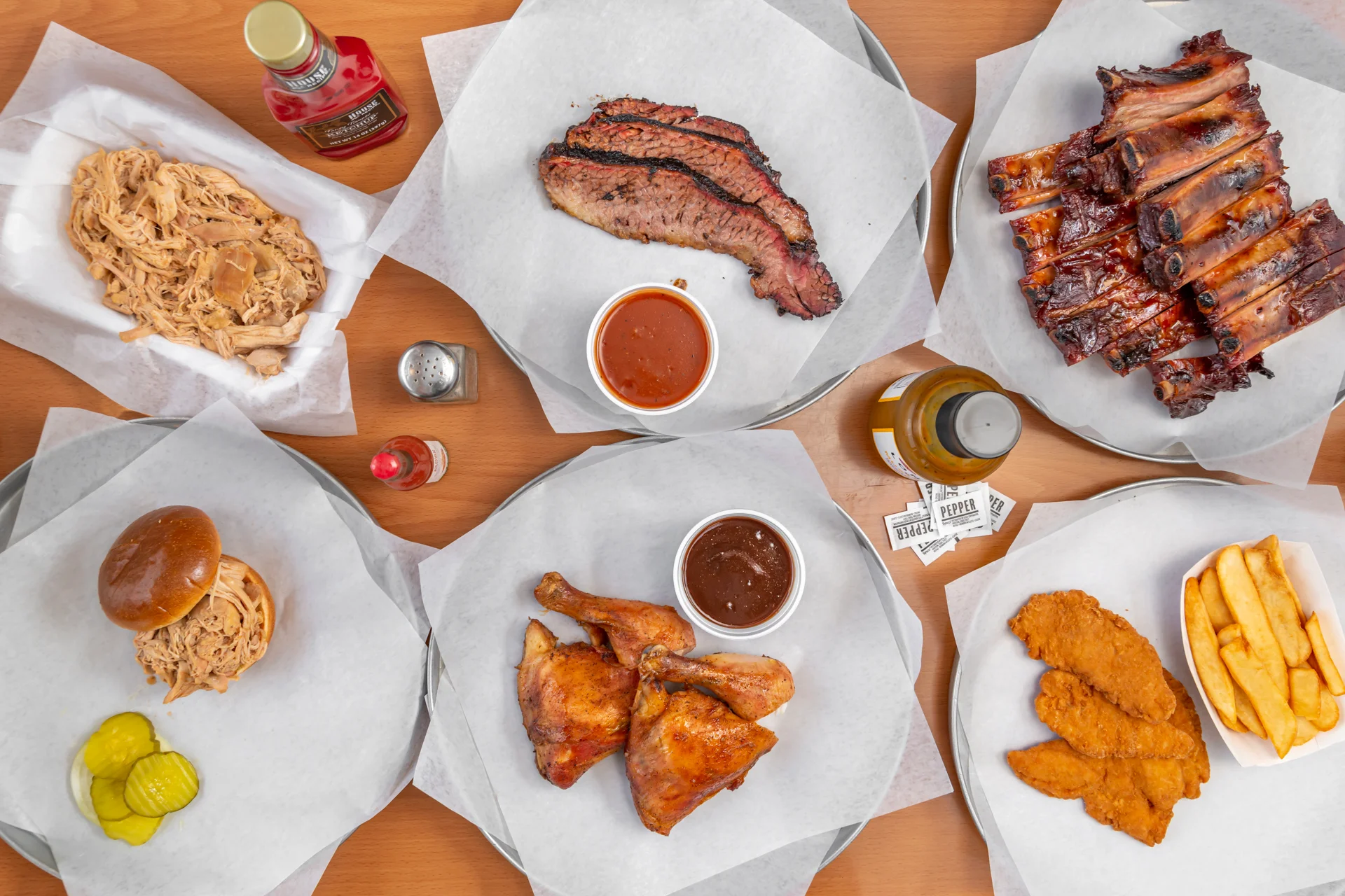 Assorted barbecue platter featuring pulled pork and ribs