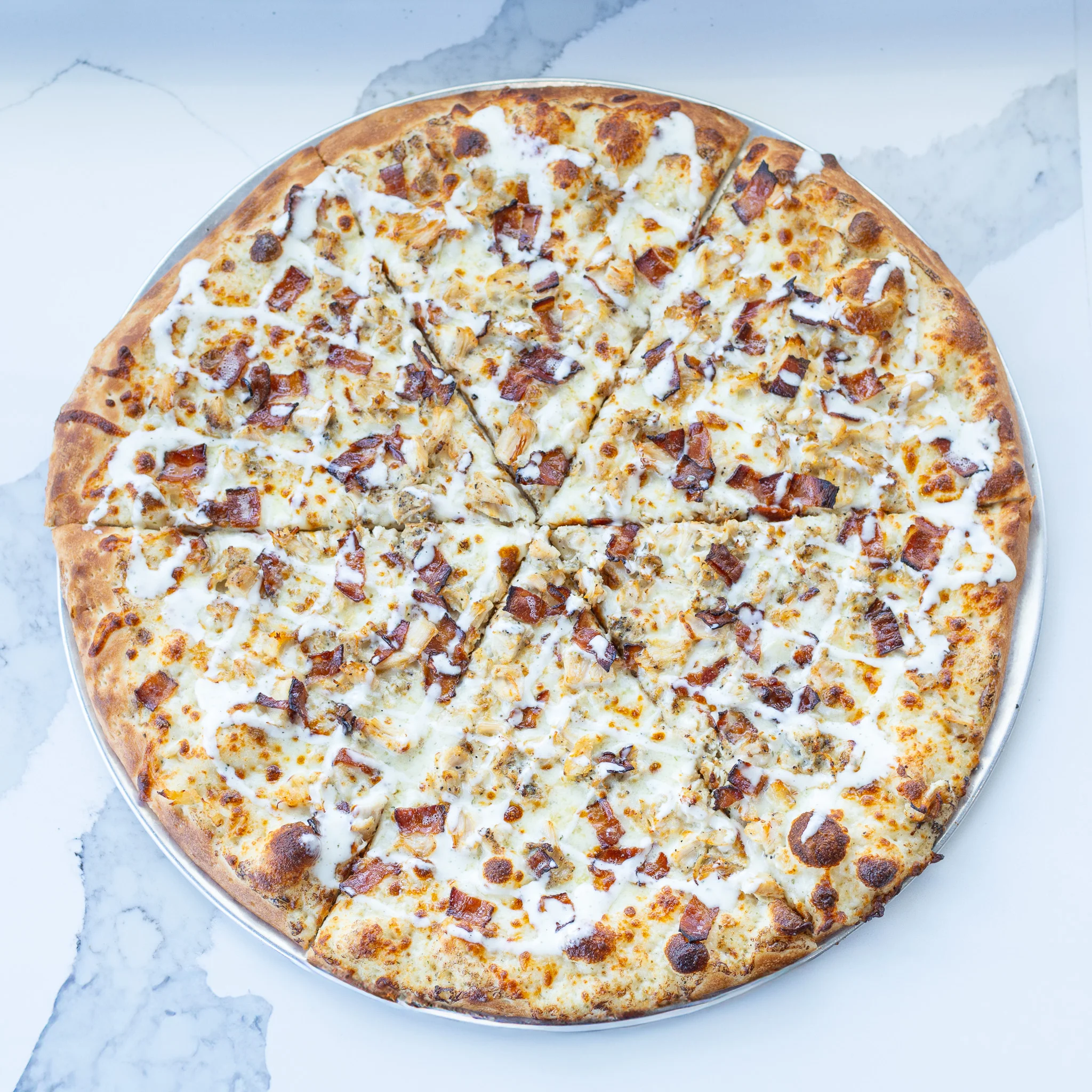 A white pizza with fresh toppings