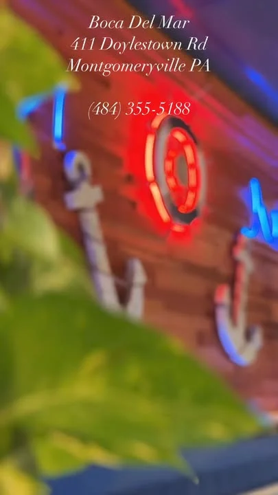 Boca Del Mar restaurant sign with vibrant neon lights